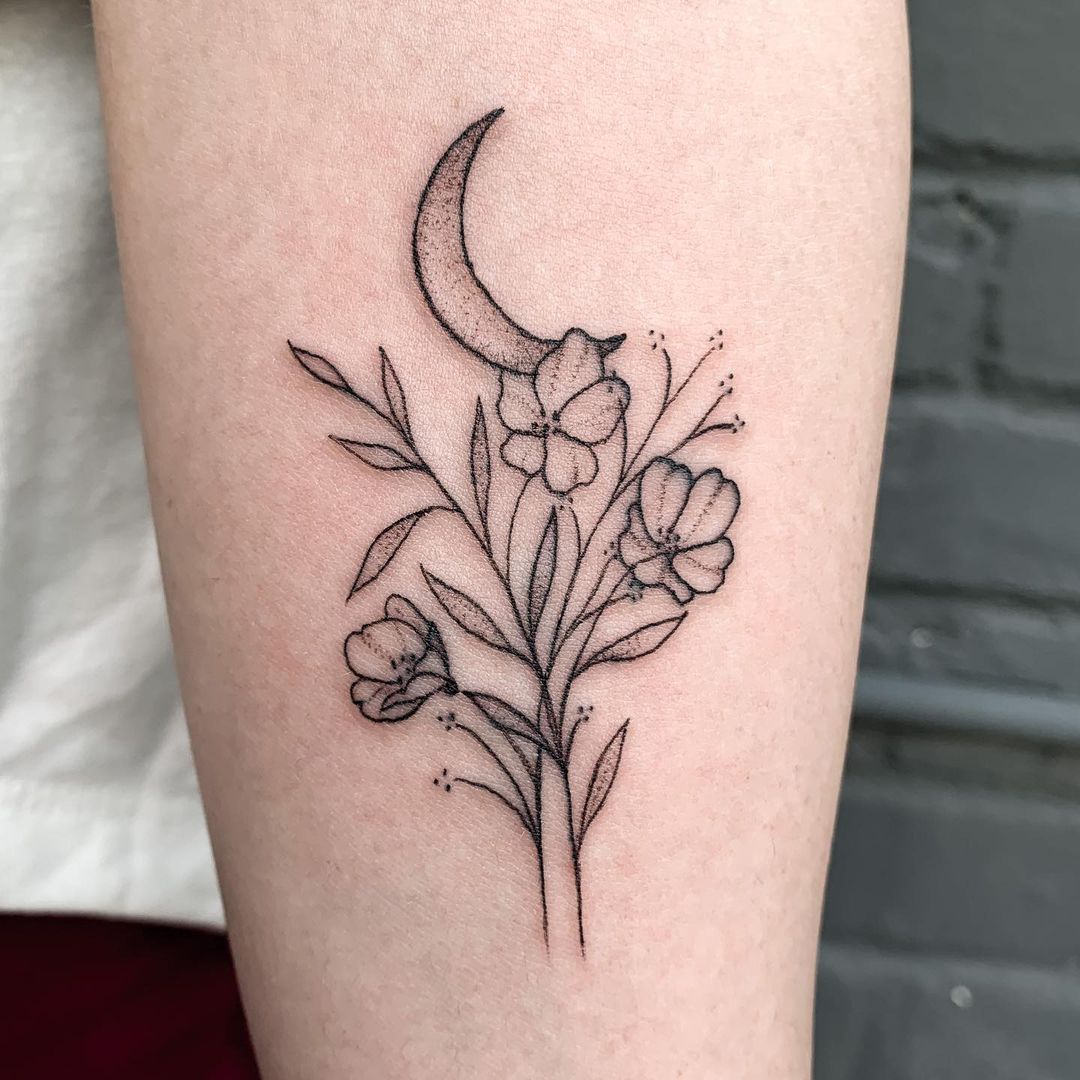Minimalist flower moon tattoo on the wrist