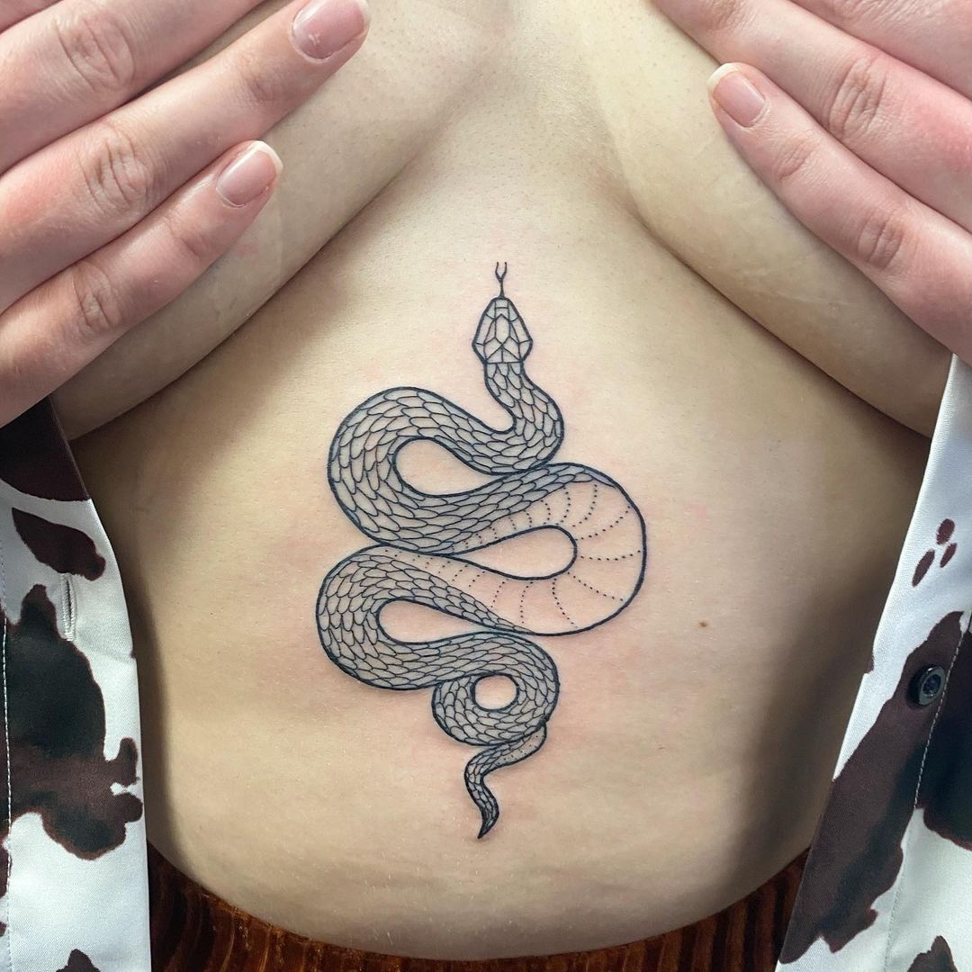 Minimalist black snake tattoo on the sternum