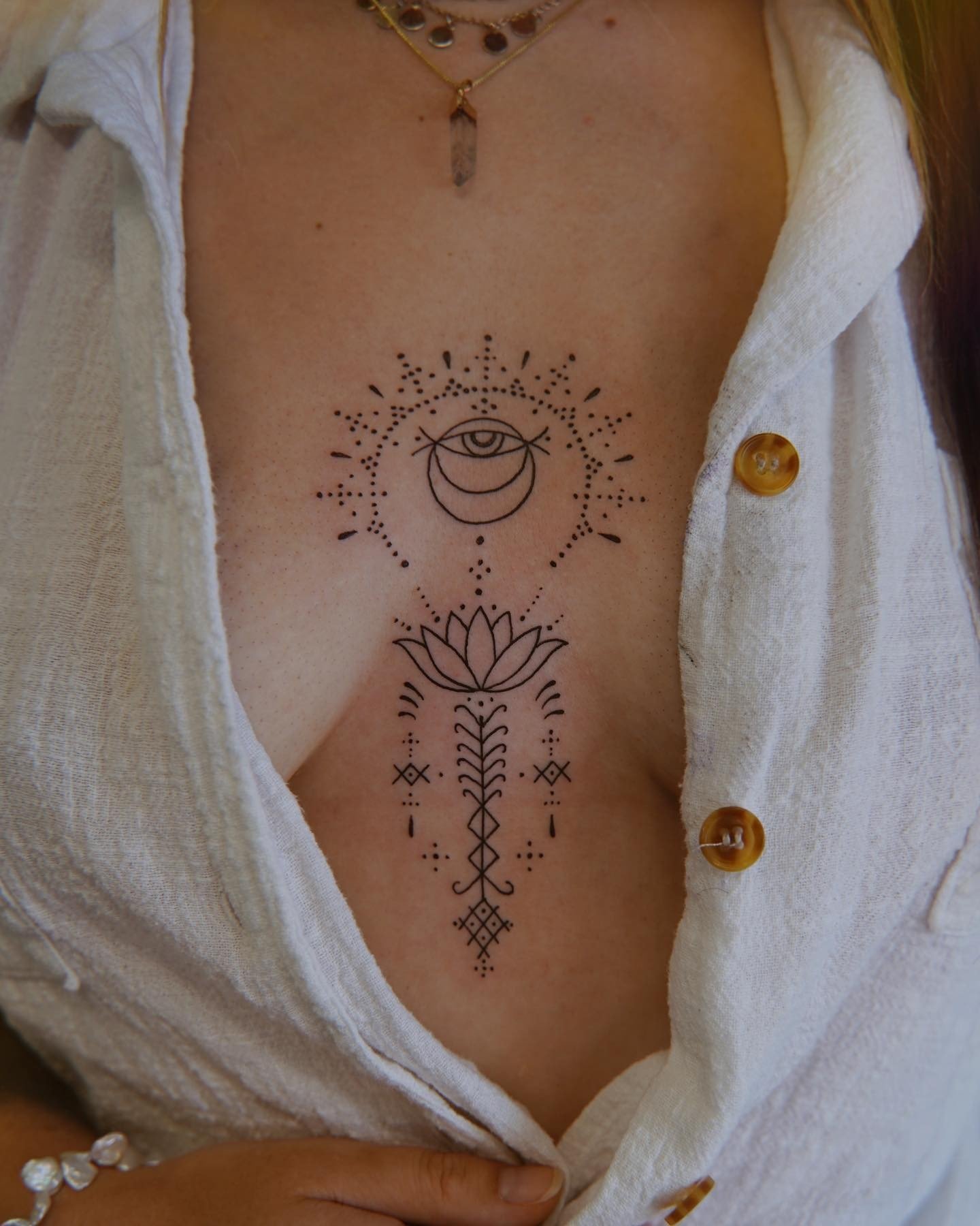 Fine line ornamental sun and moon tattoo located on the