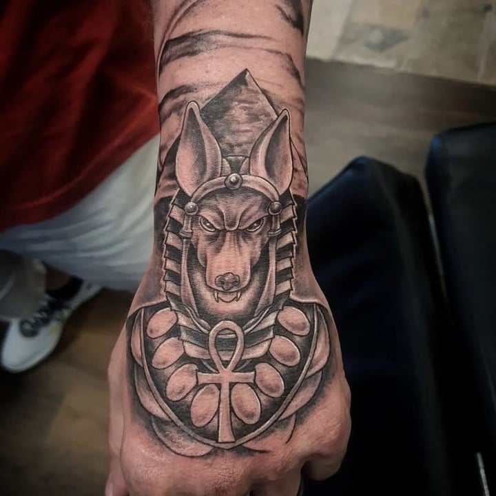 Hand can be a nice part of body for an awesome Anubis tattoo.