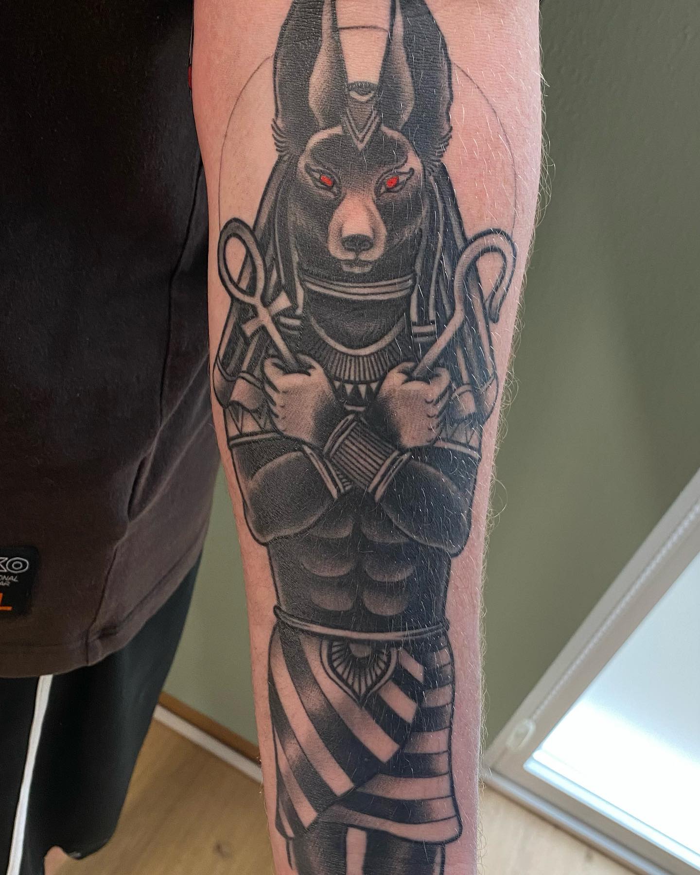 A well-designed Anubis tattoo on forearm is all you need to shine.