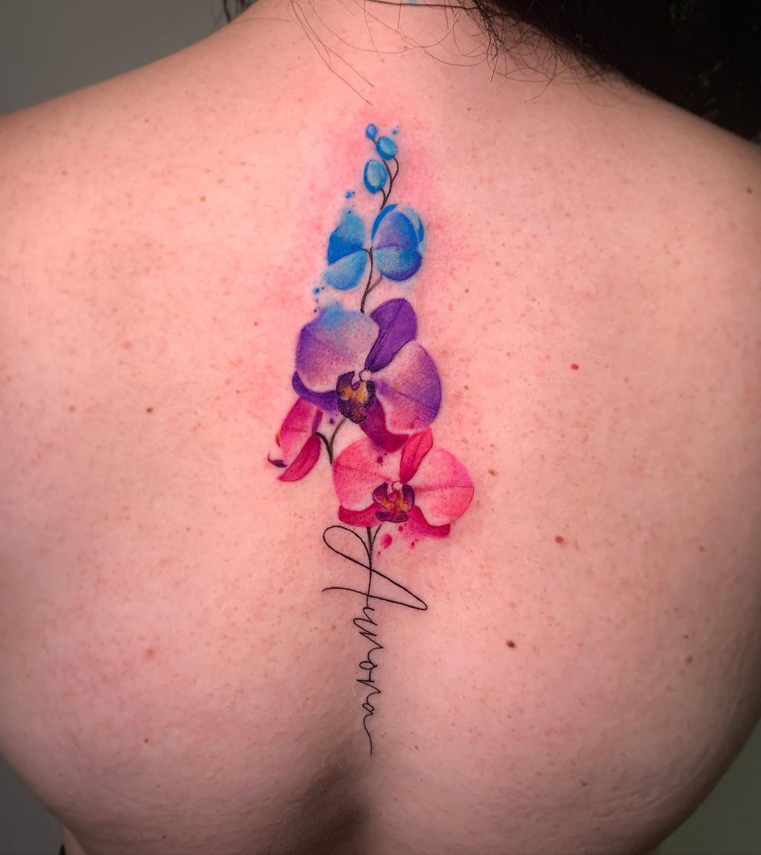 Fine line orchid tattoo on the shoulder