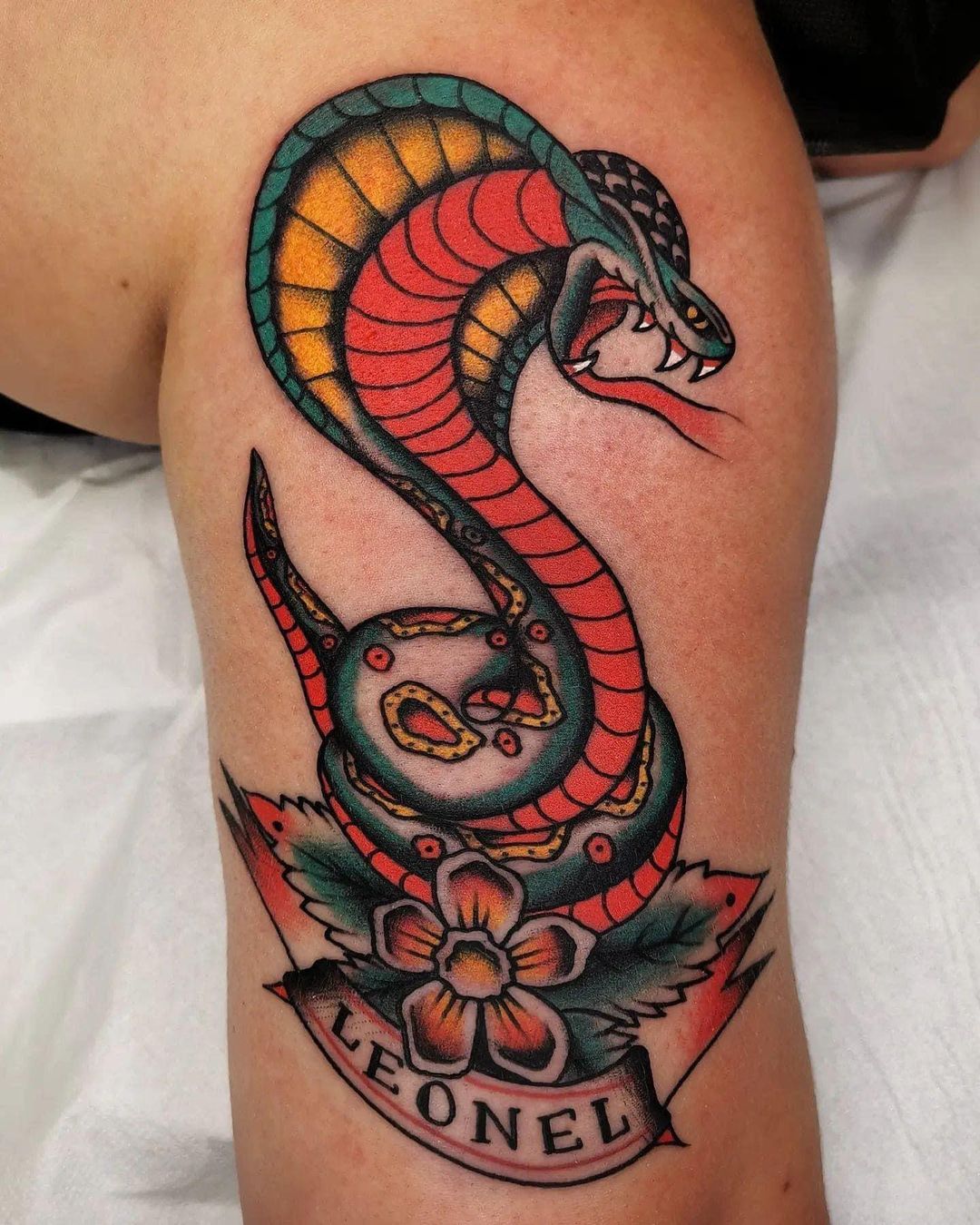 Tattoo of a snake located on the shoulder blade