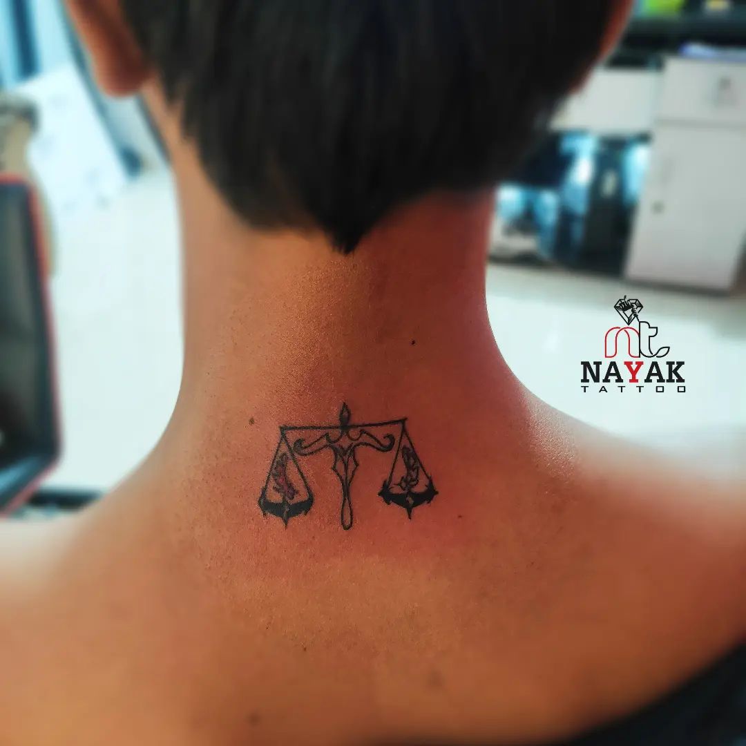 Show that you're a believer of justice with a pair of scales tattoo on your neck.