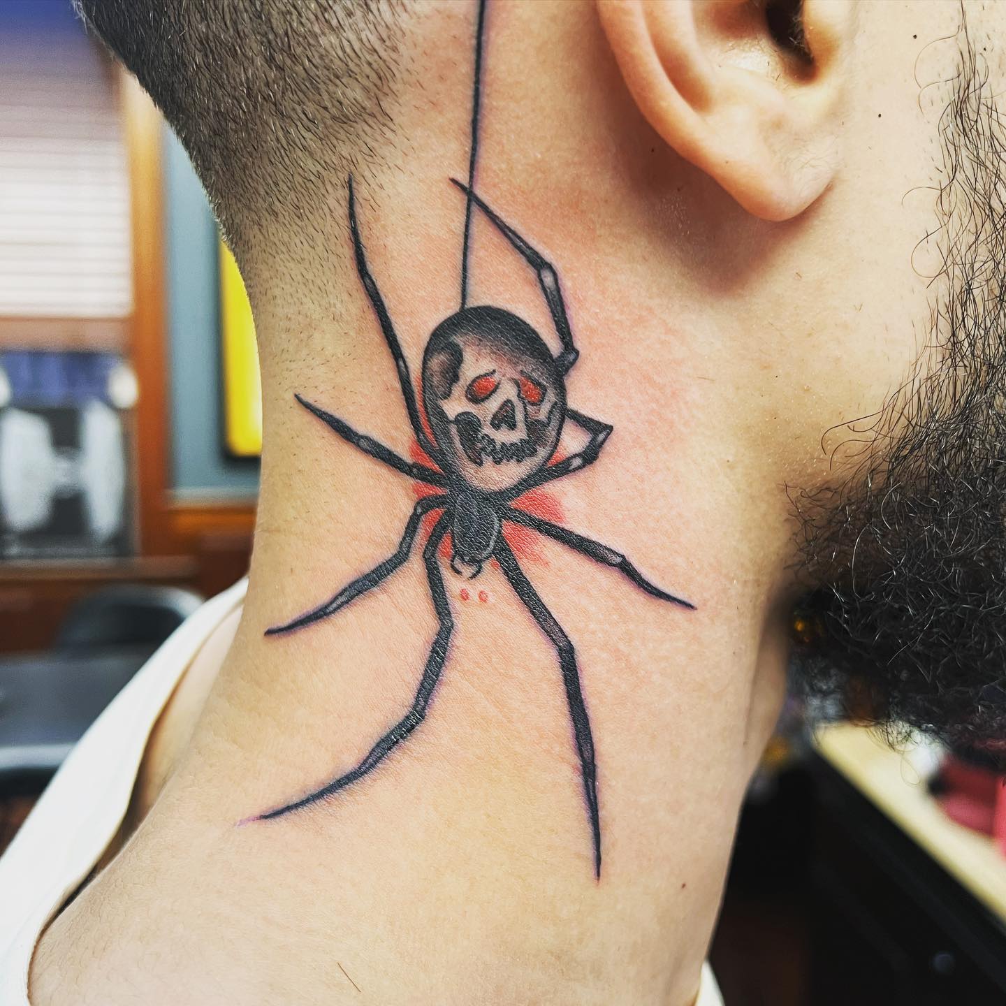 A spider with horrific skull neck tattoo is going to scare your friends when they see it. But that's what makes it more attractive.