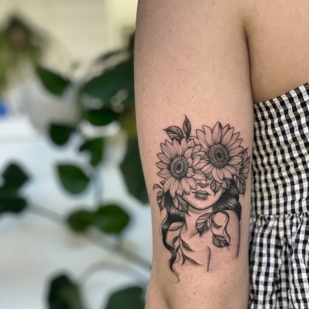 Small sunflower tattoo on the inner arm