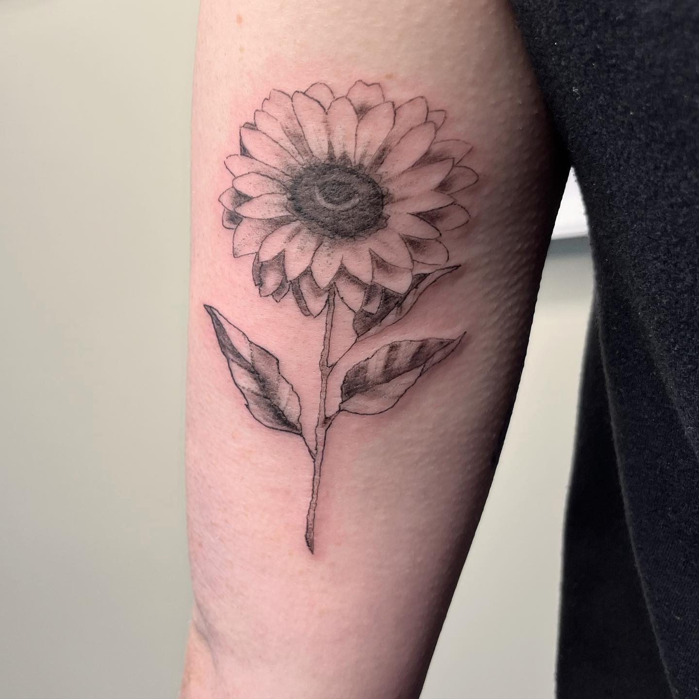 Sunflower with name by Santa Clause tattoo