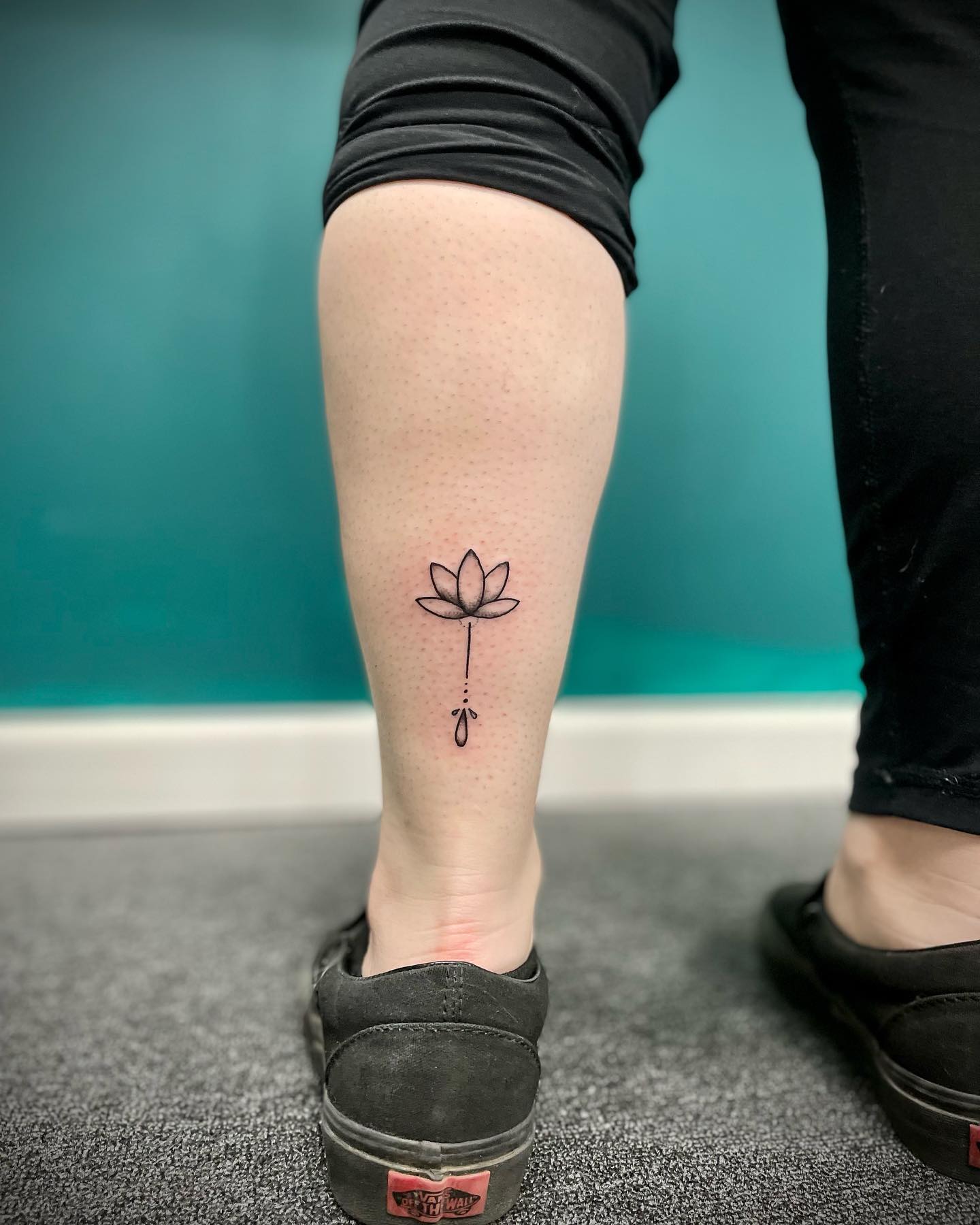 Tiny lotus flower tattoo on the ankle