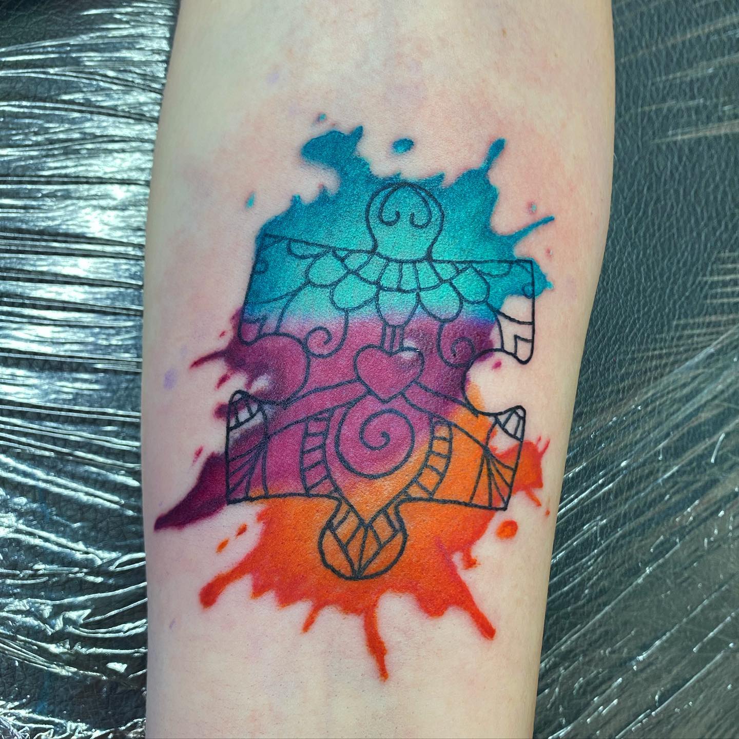 A splash of color and this loud tattoo is the right representation of how things can look in someone’s head, especially if they have autism.