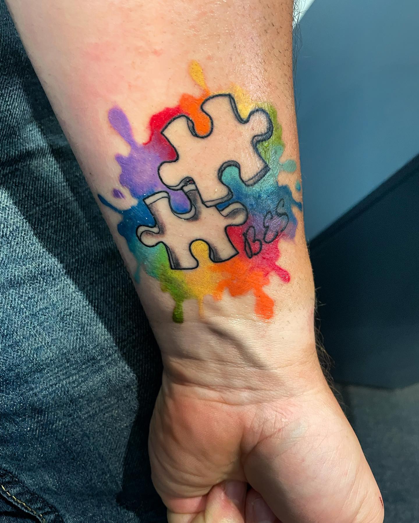 This puzzle piece tattoo with bright loud colors will make an impact at all times.