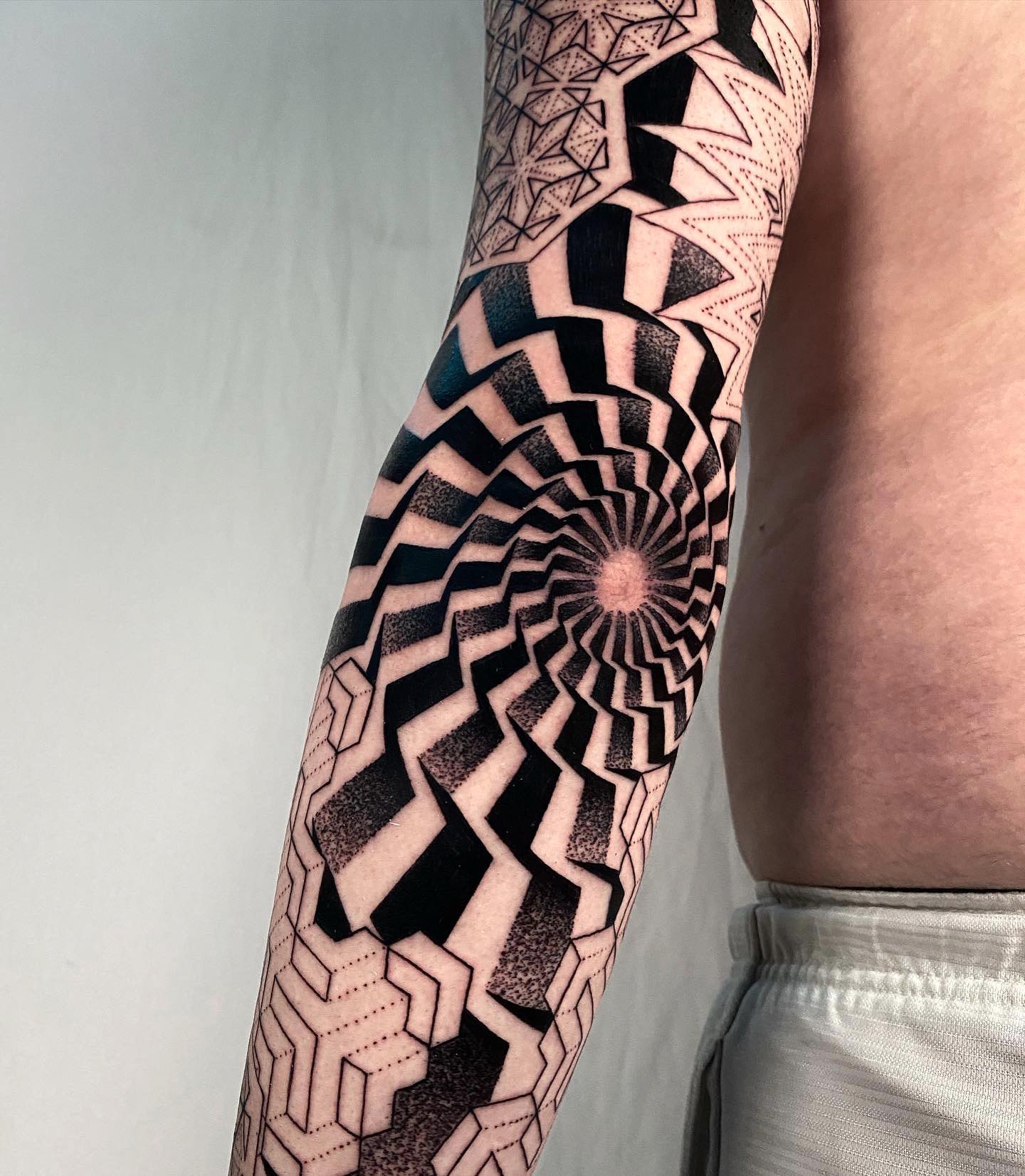 Cool elbow tattoo that has a bit of that Sci-fi element to it. If you’re into black ink and you like illusions, this tattoo will suit you. It is a masterpiece, often worn by those who like dramatic and cool tattoos.