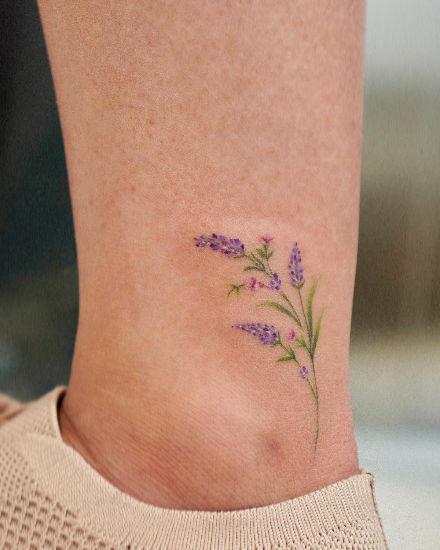 If purple is your favorite color, why not try out this purple flower? It shows and embraces feminism, warmth, and true love. It is a small and sweet tattoo, a must-try by those who like minimalism.