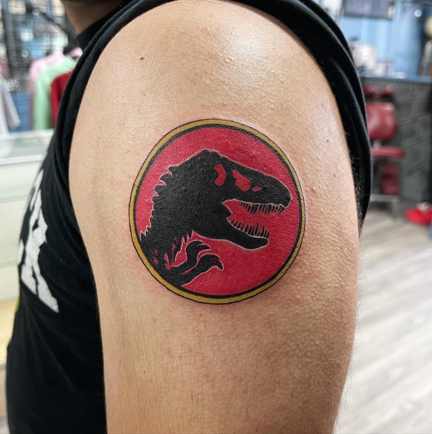 If Jurassic World or Jurassic Park is one of your favorite movies give it a go with this black and red shoulder tattoo.
