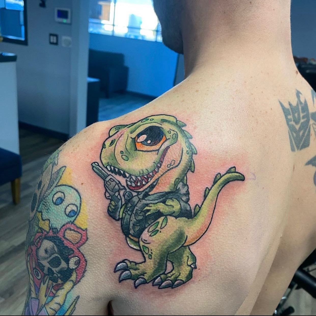 Simple and cute, this dinosaur cartoon tattoo is for those who fancy funny and creative ideas + guys who are still kids at heart.