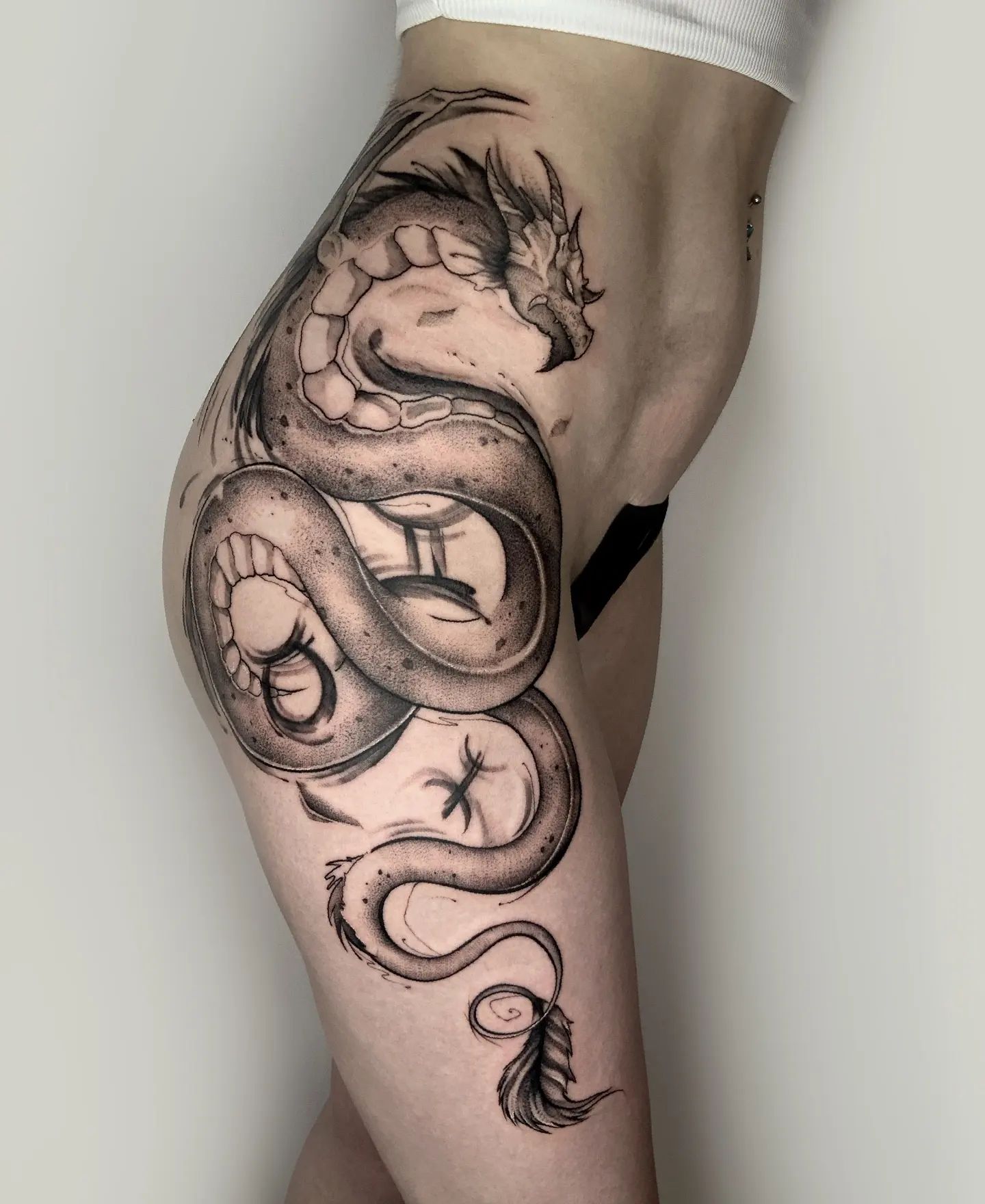 Show off your inner dragon and try out this giant mysterious print. If you fancy big and bold tattoos, this will suit you. In the end, women who like sexy ideas and those who have a lot of space to work with will like this hip creation.