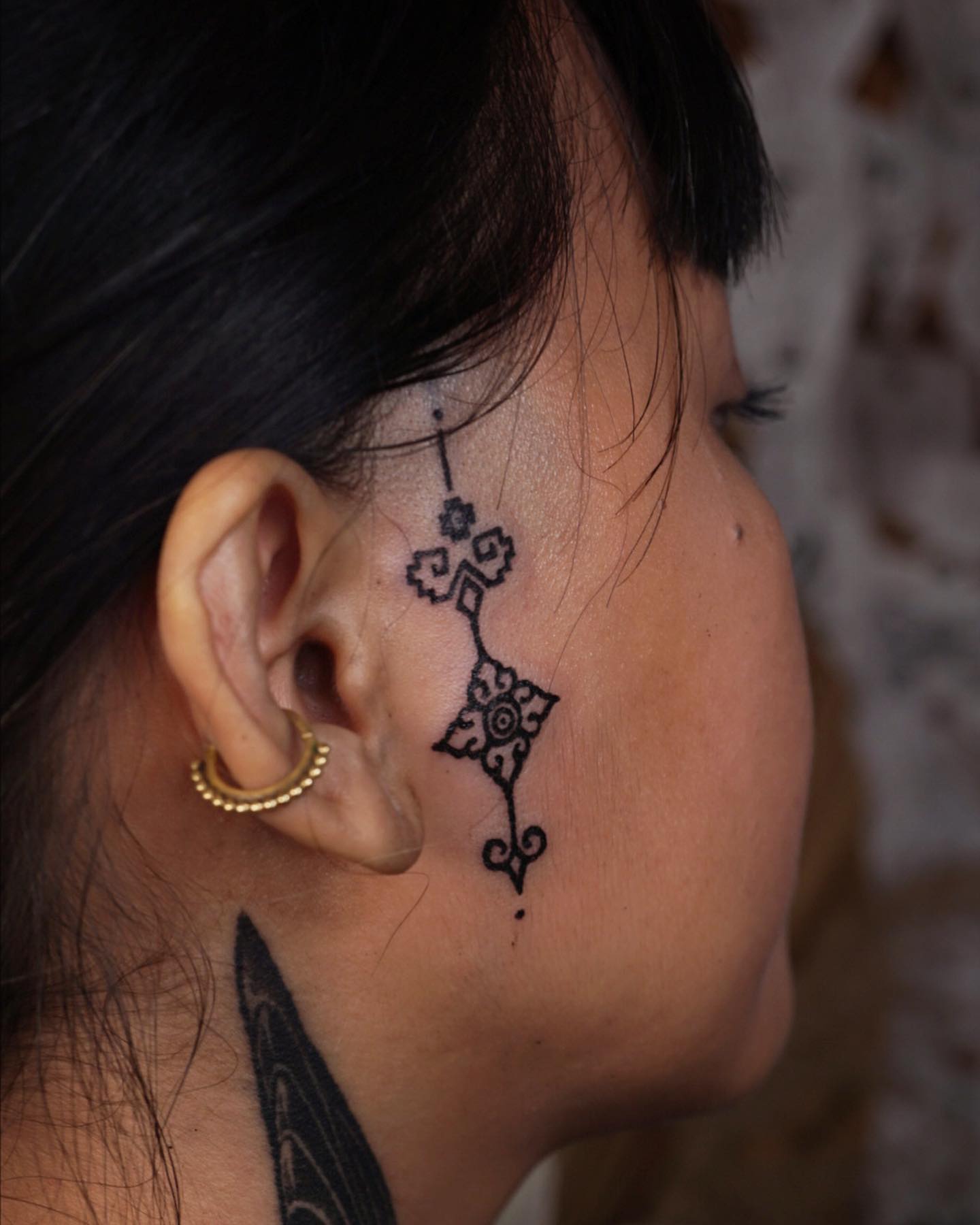 If you like mysterious and boho tattoos and you like to look retro, this face tattoo is for you. It is a spiritual piece that most women will enjoy.