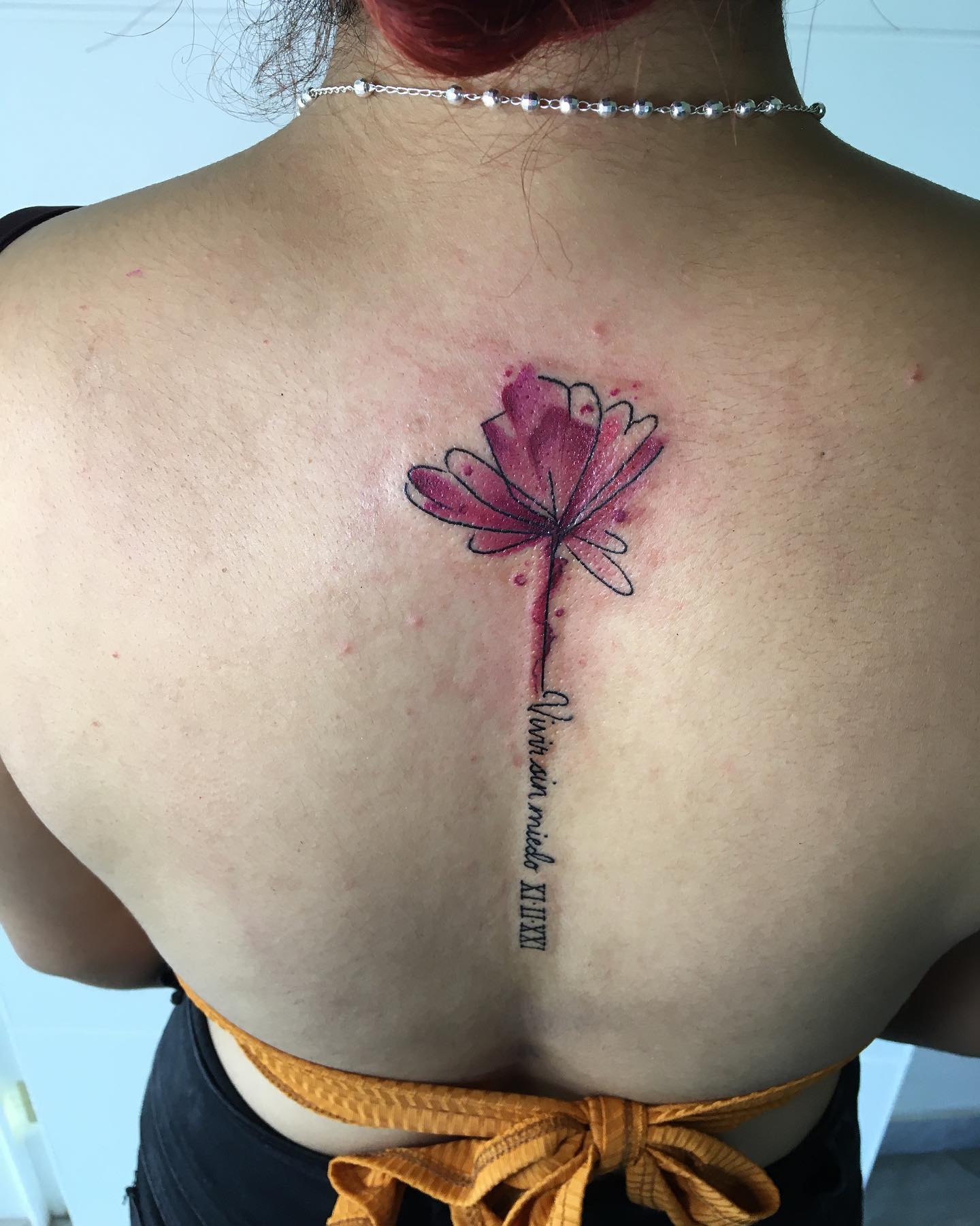 This pink flower tattoo along with a symbolic quote will suit those who fancy sentimental pieces the best.