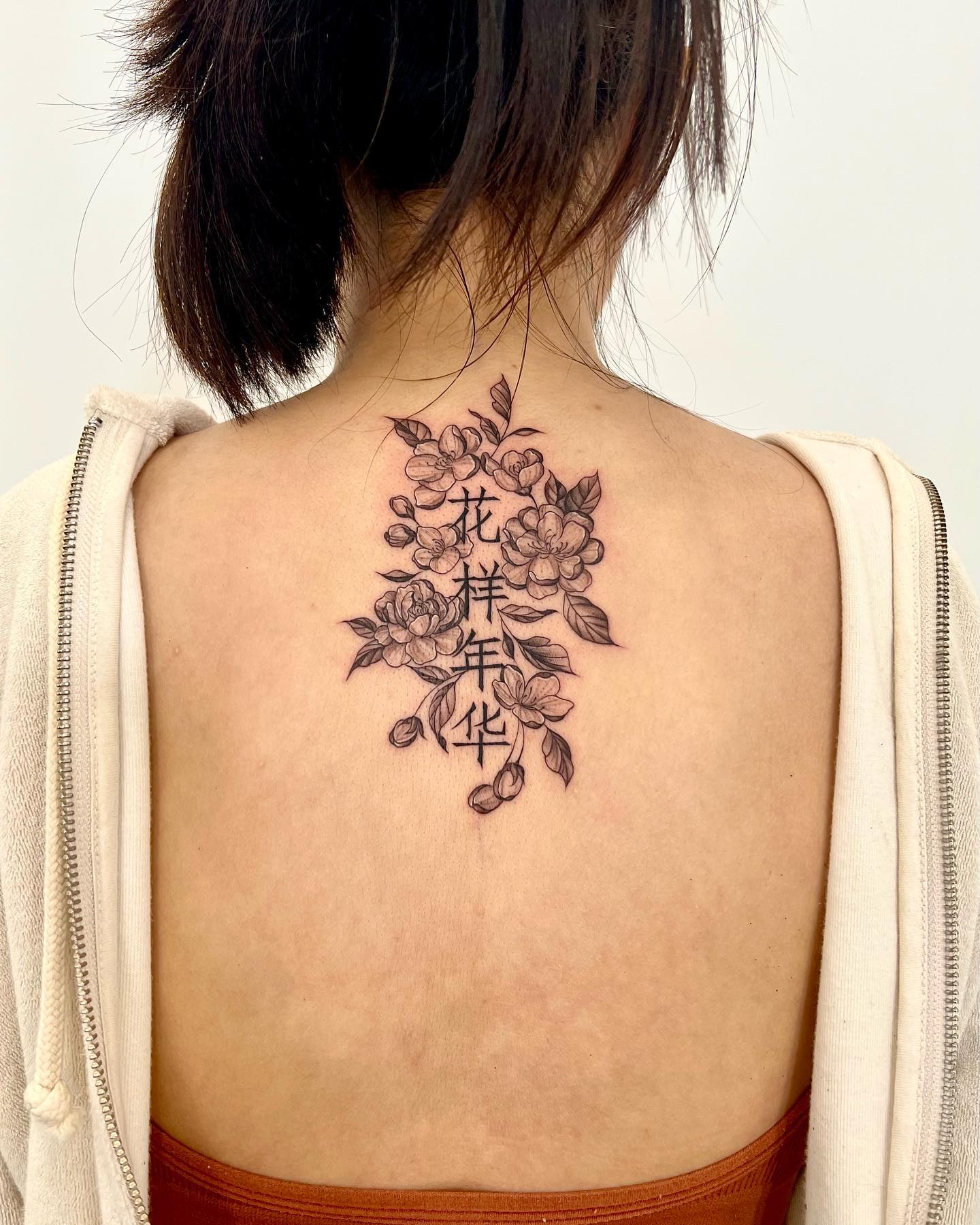 A giant flower tattoo with Chinese lettering is for women who want something sweet, only known to them and that others can’t decipher as easily.
