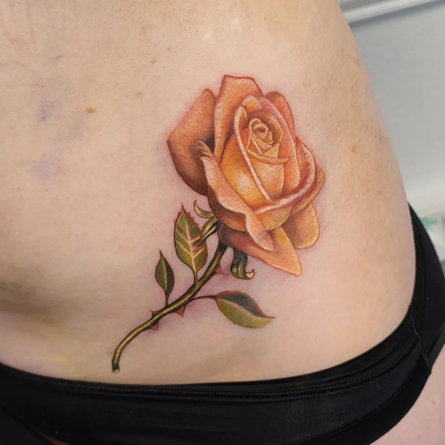 A tattoo on your hip can look so fun and feminine. Show that you’re a soft soul who likes natural beauty with this light orange design. A tattoo such as this one will take you 2-3 hours to get.