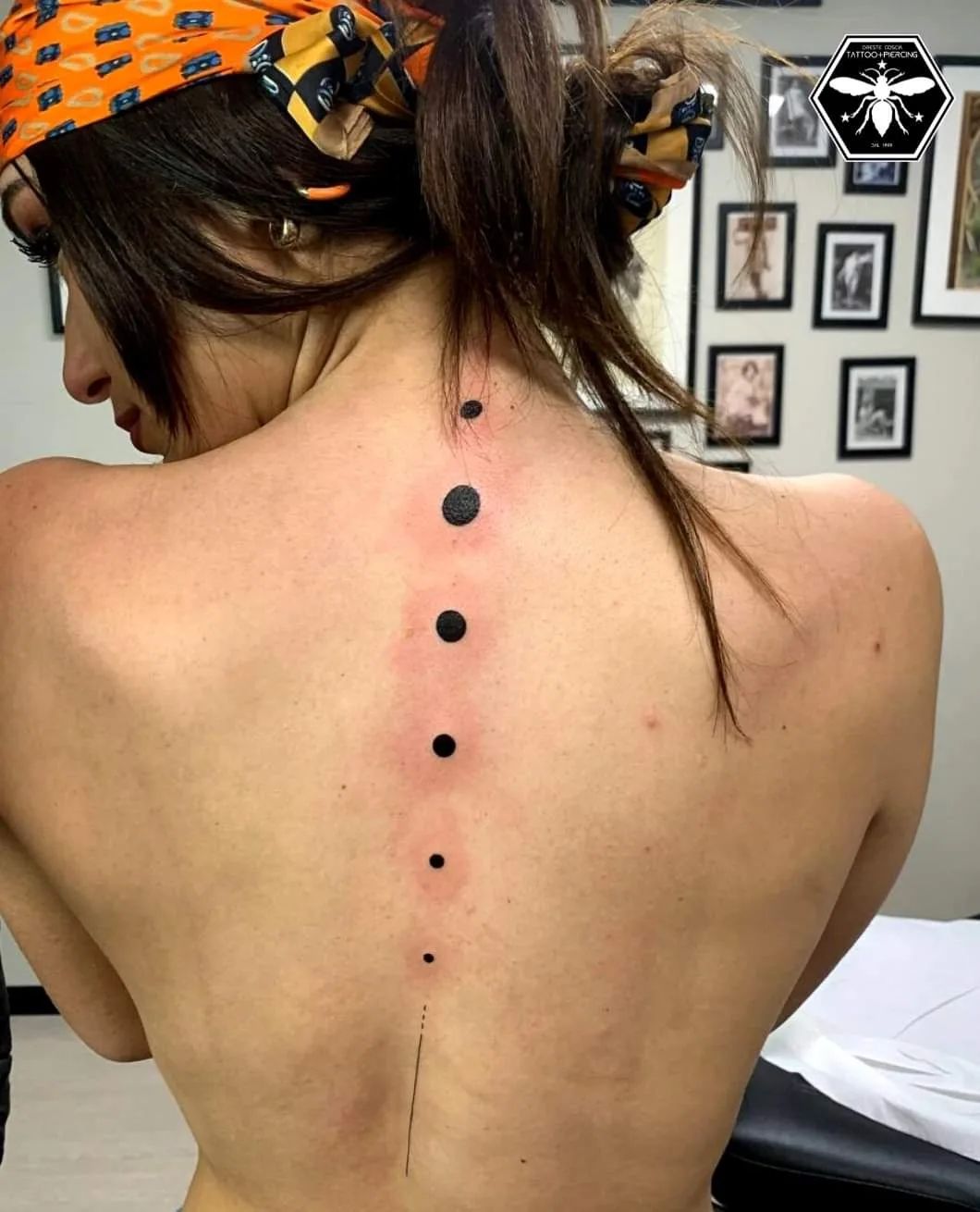 Show all the phases of the moon with this cool back black ink tattoo.