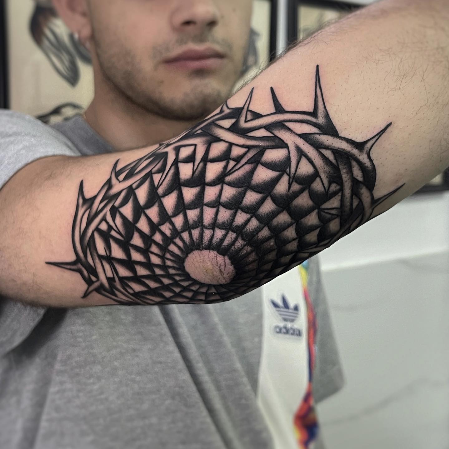 This spider web tattoo will be tricky to get due to its elbow placement. Do you fancy something wild and different?