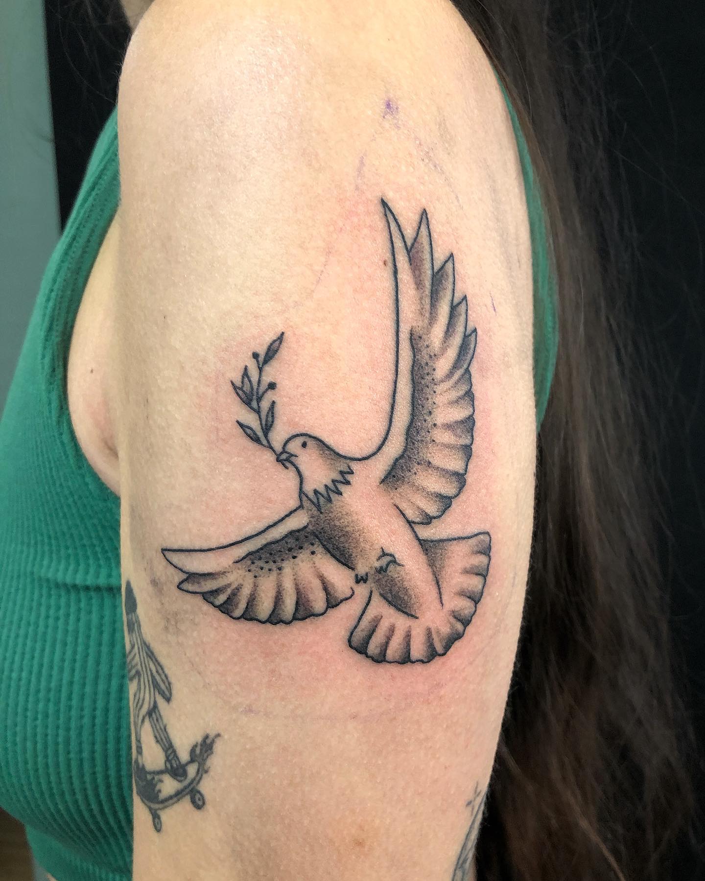 Microrealistic style dove tattoo located on the