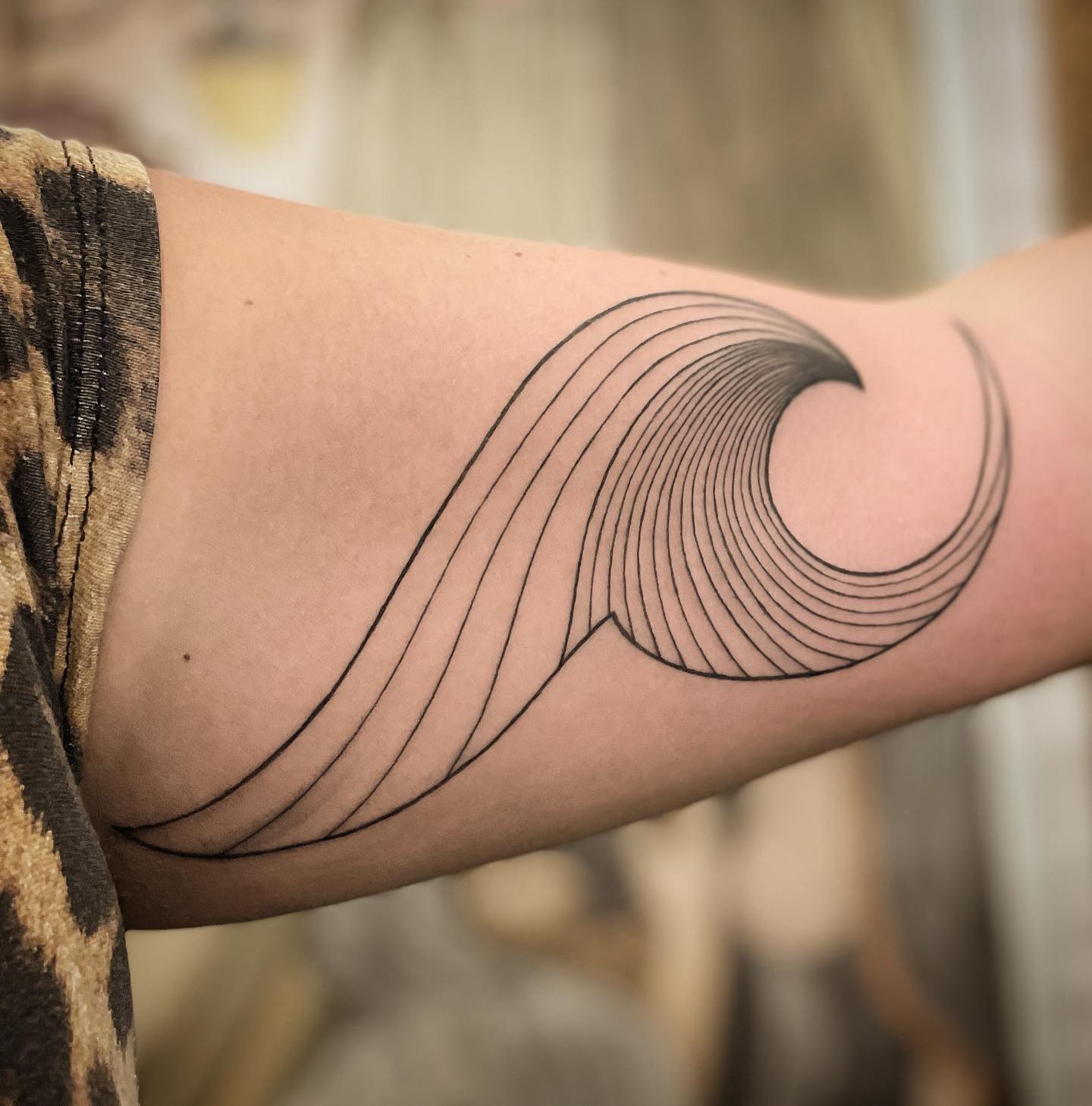 Shoulder tribal tattoo with wave and feather