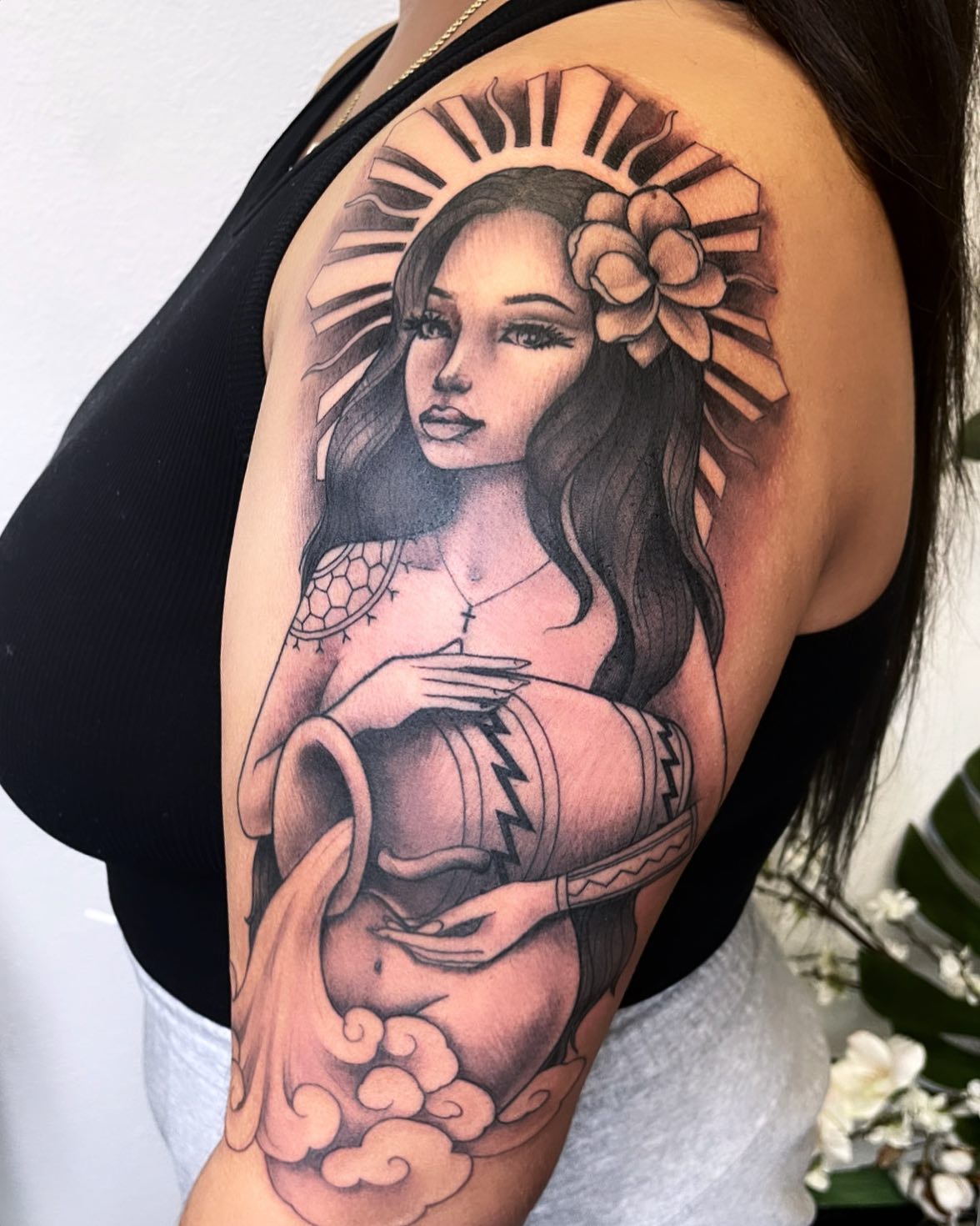 Cover tattoos look amazing if they are done on sleeve, especially starting from your shoulder. A beautiful and holy girl holding water in her hands offers a look that is so unique. This Aquarius girl is wearing a cross necklace but you can change the sign according to your own religion, of course.