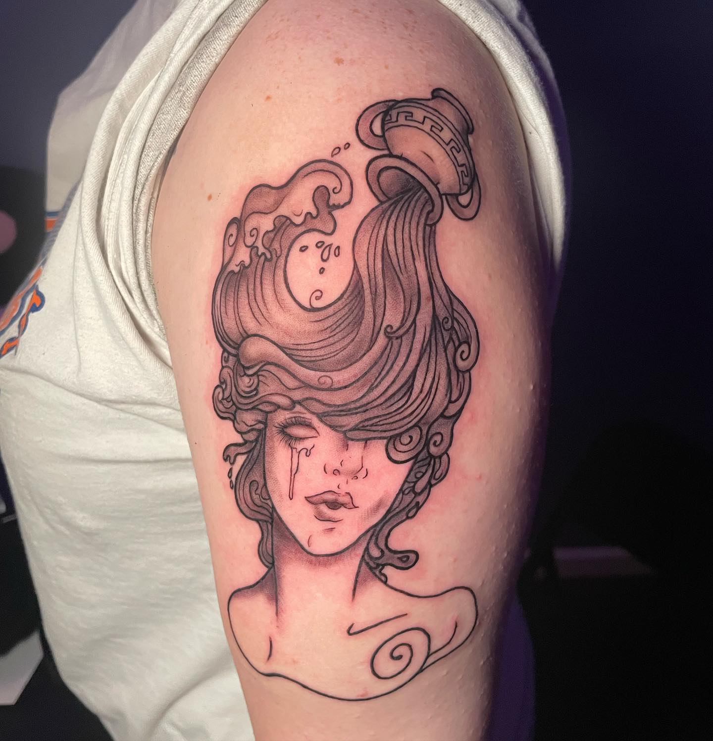 Are you looking for an Aquarius tattoo that is quite amazing? Then, you should go for this one. In this bust, the woman's hair is created with the running water. She is weeping but we all know that she is super-strong. I mean, she is Aquarius.