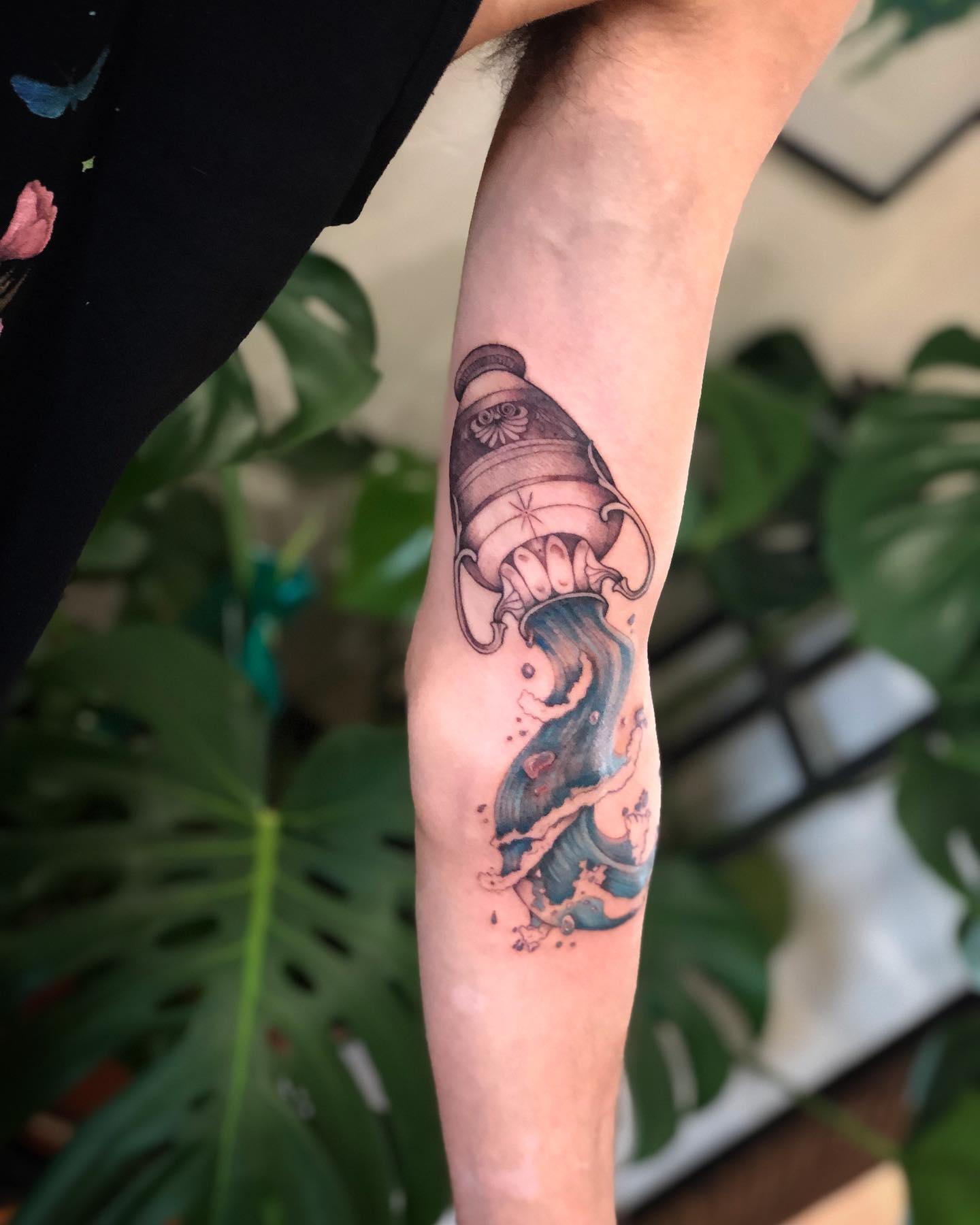 In order to give your arm a quite different and amazing look, you can wear your zodiac sign. Big size bucket is upside down and the water is poured down in this tattoo design. Show your free soul with it.