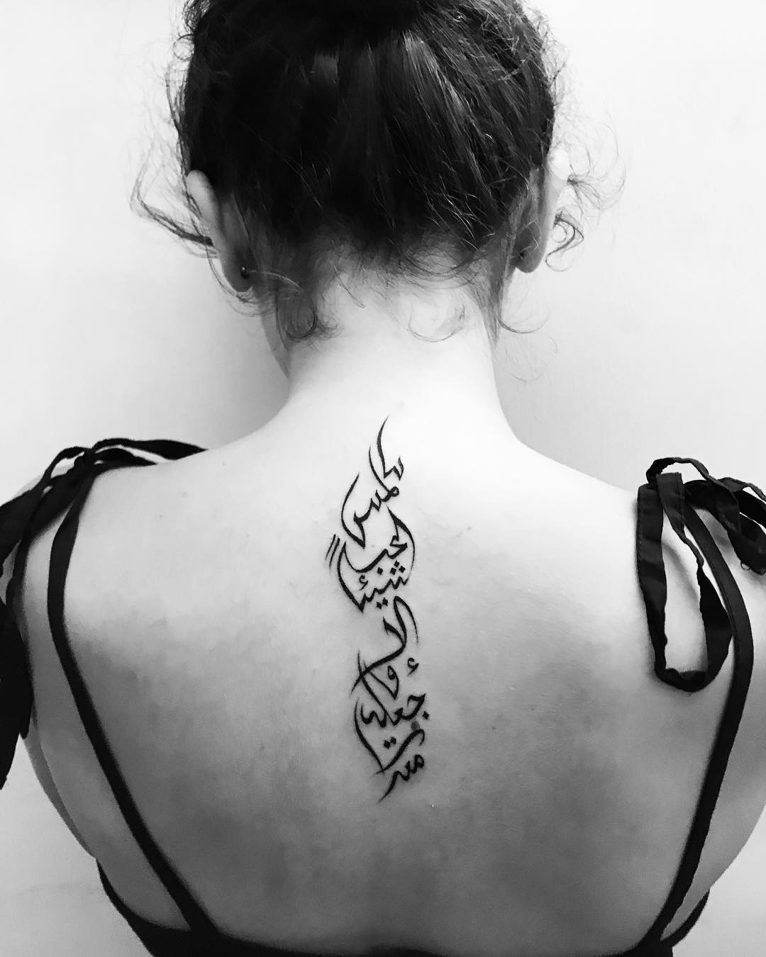 Nothing is cooler than a back tattoo and we all know this fact. To make it look cooler, arabic words are a perfect choice.