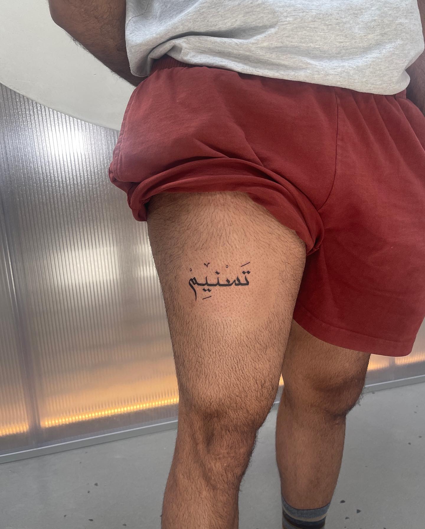 Here is a tattoo of a special name in Arabic. It's called tasnim and it has an amazing meaning: A spring in paradise.