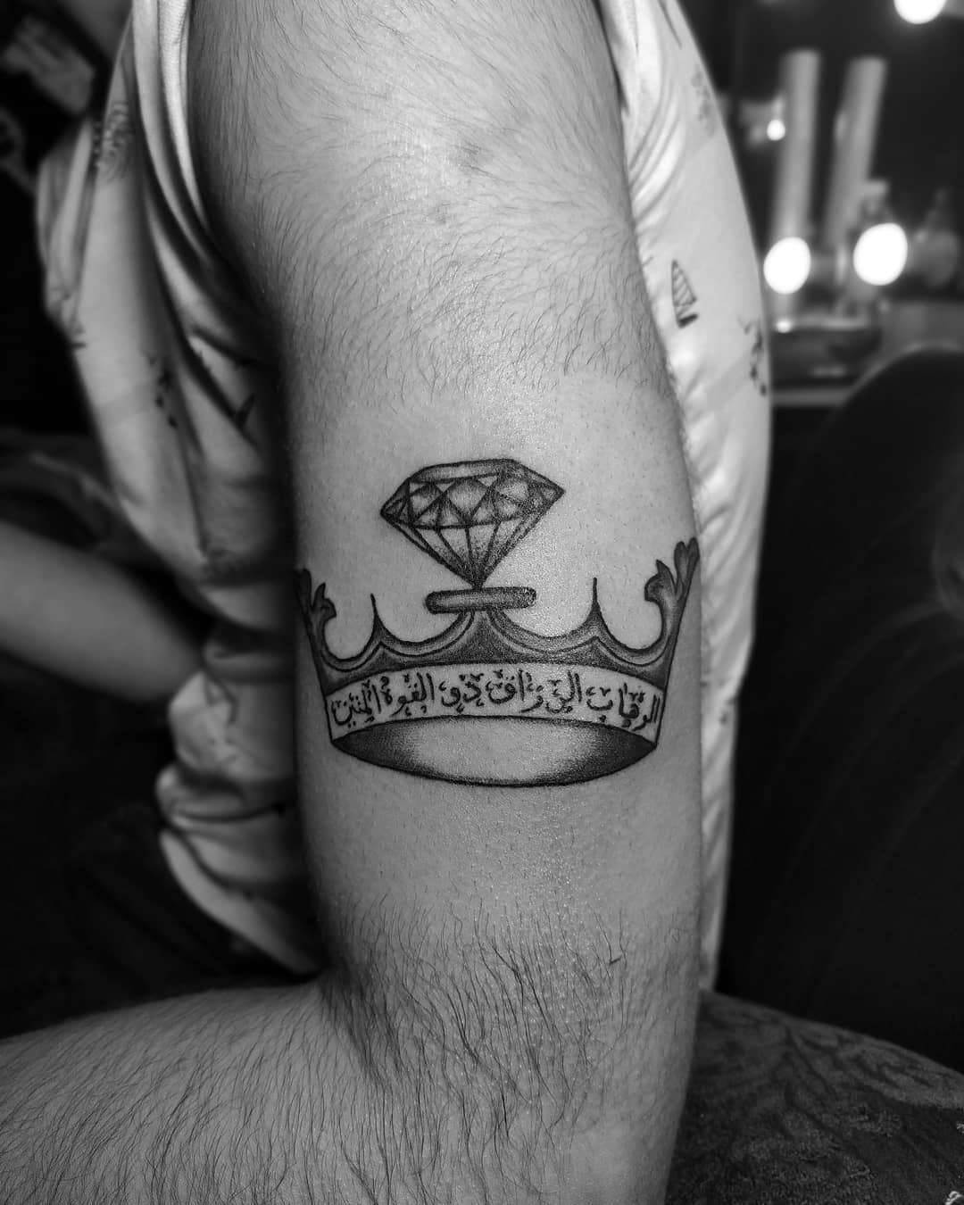 Crown tattoos have always been one of the most popular choices. You can add Arabic words below it to make it more gorgeous.