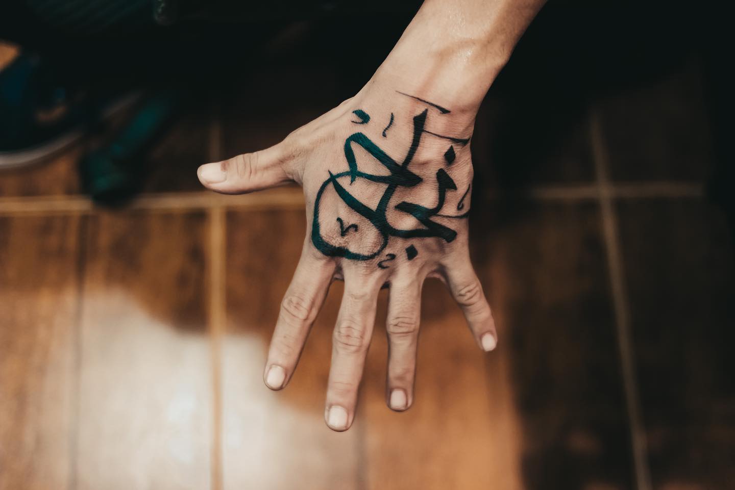 A hand tattoo with a significant Arabic character. This tattoo is definitely for those who are bold to get something like this.