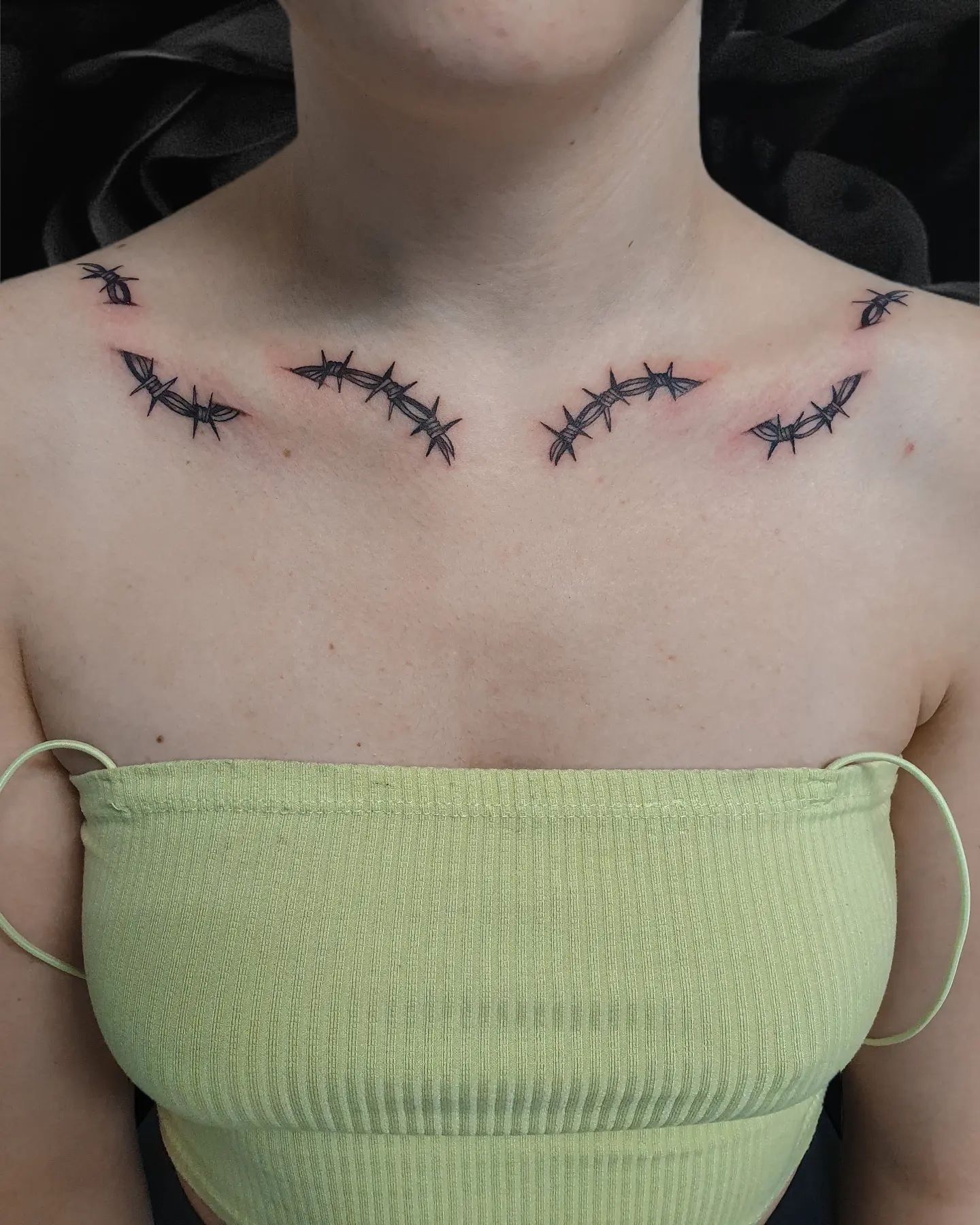  Collar bone tattoos are super sexy, aren't they? However, this one is only for those who are bold enough to get it. Small and simple barbed wires get together in your collar bone separately to make you shine. It is quite extraordinary and it will change your look forever. Are you ready for it?