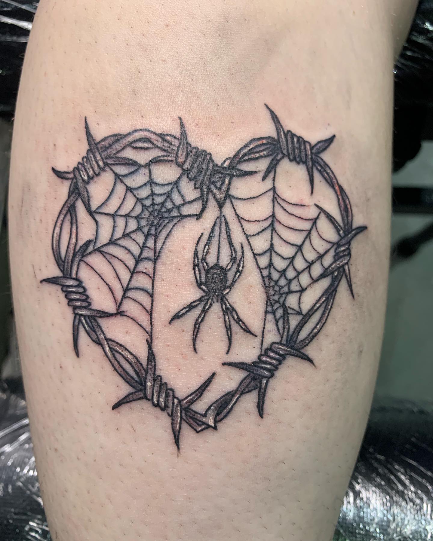 Barbed wire heart is worth a try if you want to get some fresh ink to look amazing. As a nice detail, the spider inside the heart looks like he has made a net to give it a heart shape. The barbed wire and the net are ready to save you from any harm.