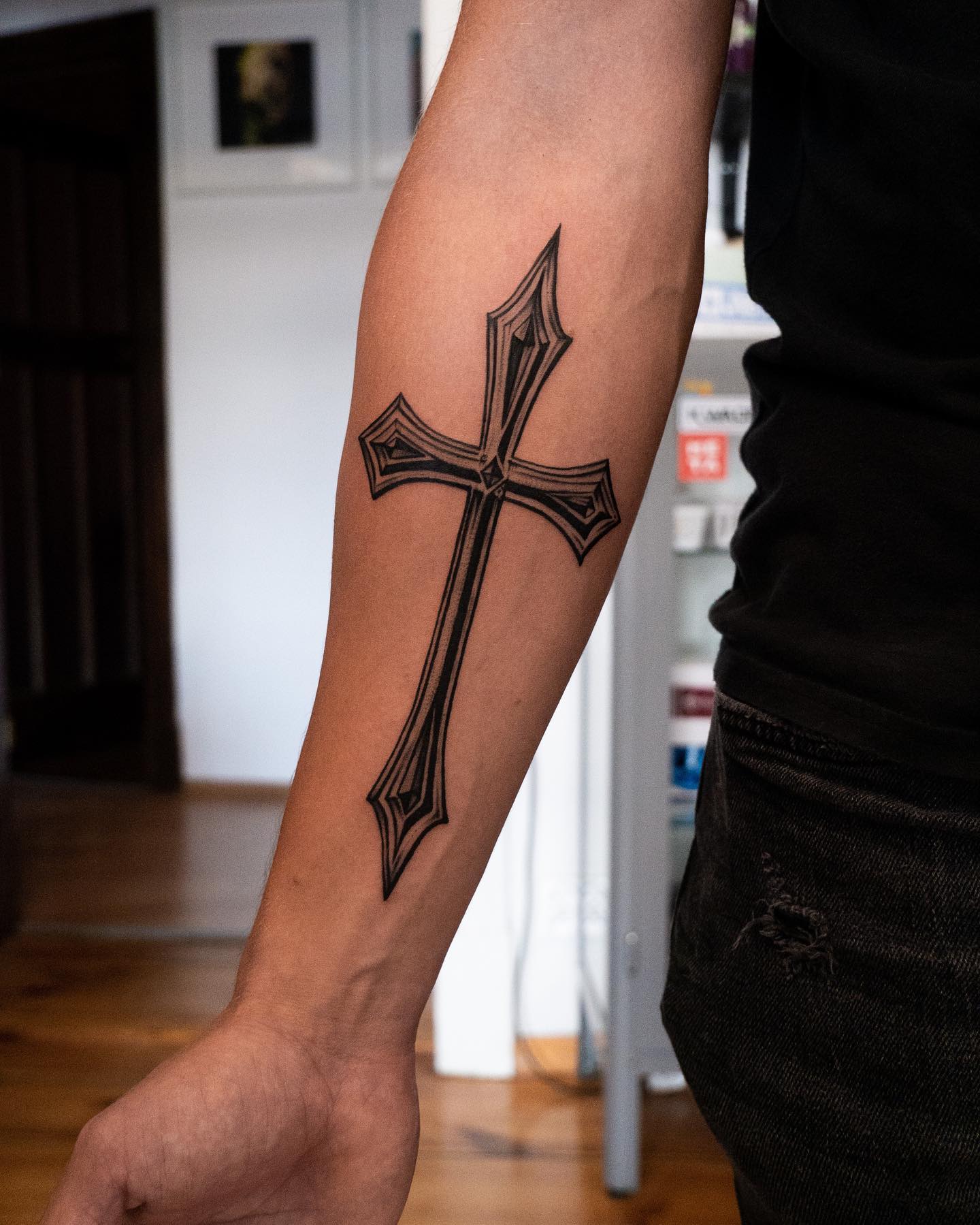 Here is another design of a cross tattoo. Covering up your forearm can be a great idea if you like big size tattoos. With its thin lines, this cross is sure to offer an elegant look for everyone who gets it. Every bit of it is drawn in a perfect way.