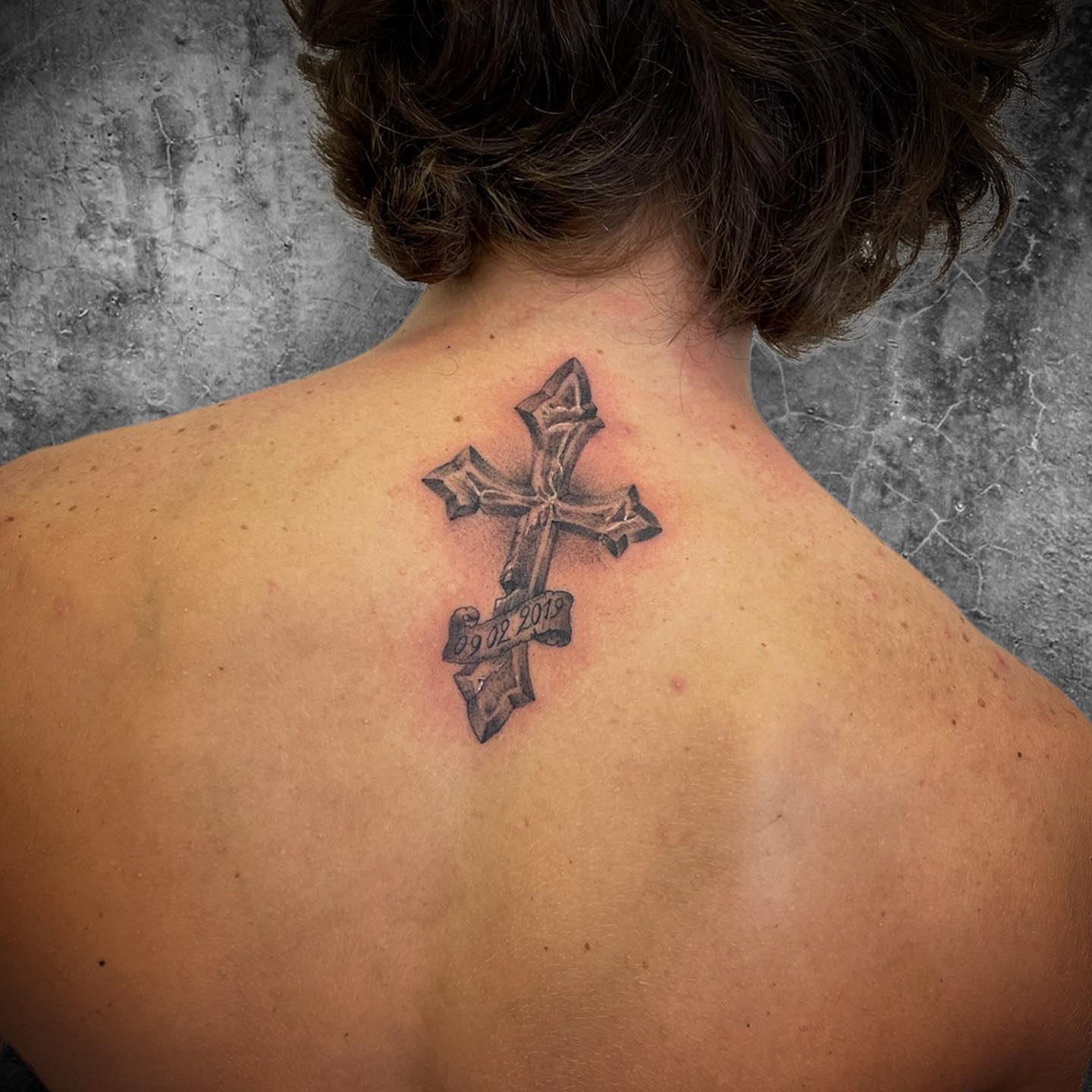 An ancient cross tattoo is ready to make you feel like you live in Middle Ages. This middle size cross above has perfect shading effects, so it offers a realistic look. As a nice detail, you can have your birth date written below it.