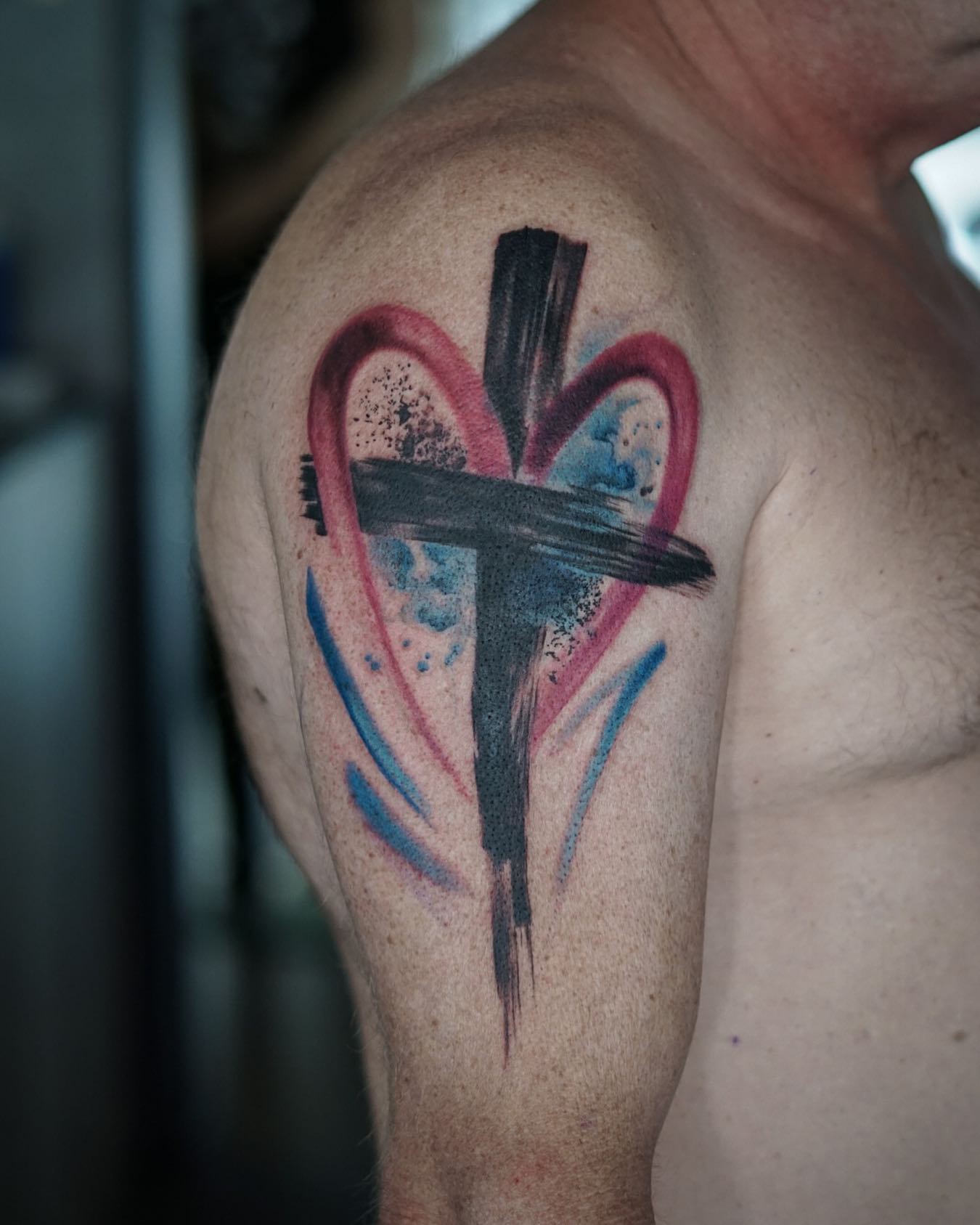 Color splash tattoos are a great way to bring back magical imagination. For your cross tattoo, you can be creative like the one above. Red heart splash is matched with a thick black splash of cross. Go and find a talented tattoo artist for it as soon as possible.