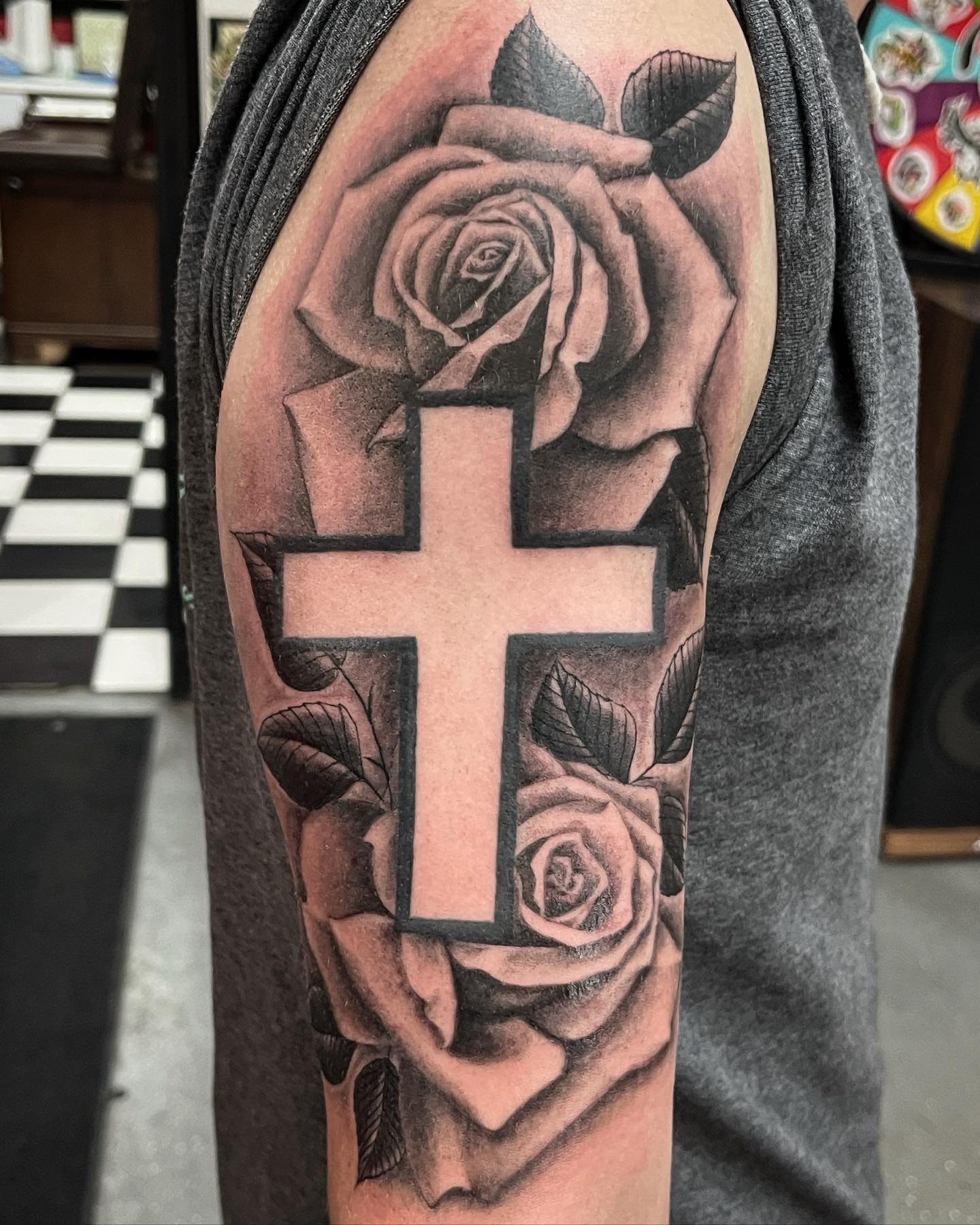 Being one of the most iconic designs for tattoos, roses are so popular. You know that roses symbolize love and romance and this meaning is what they are mostly associated with. To show your love for your religion, why don't you get a cross tattoo with roses behind?