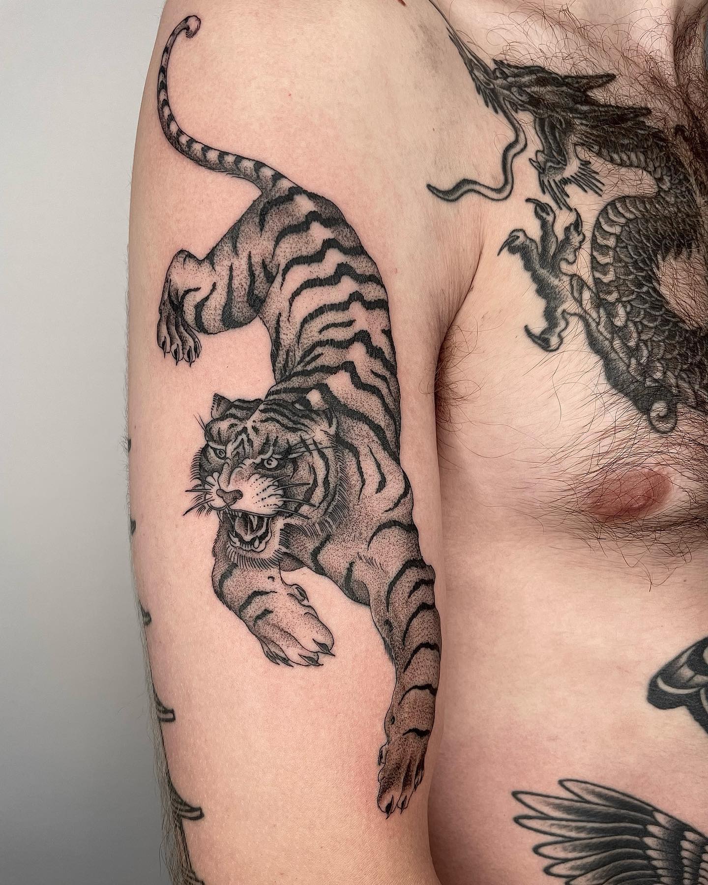 This detailed tiger tattoo has a lot of tiny dots and these make this a realistic tattoo. If you want to show your darker side, go for it.