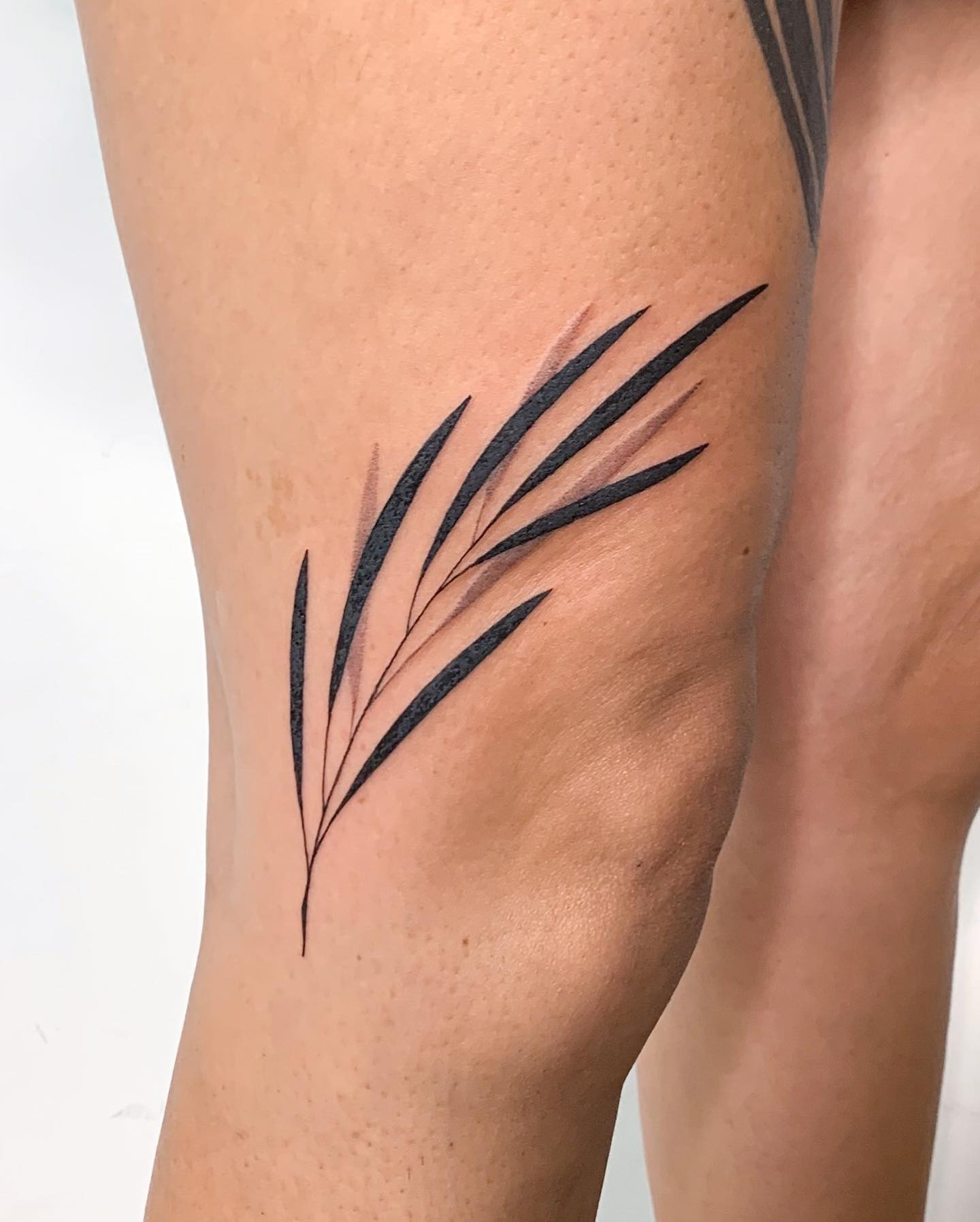 These thin leaves on upper leg look fabulous. Plus, nude colors of leaves is a super-cool idea for nude lovers. Don't wait too long to get this tattoo!