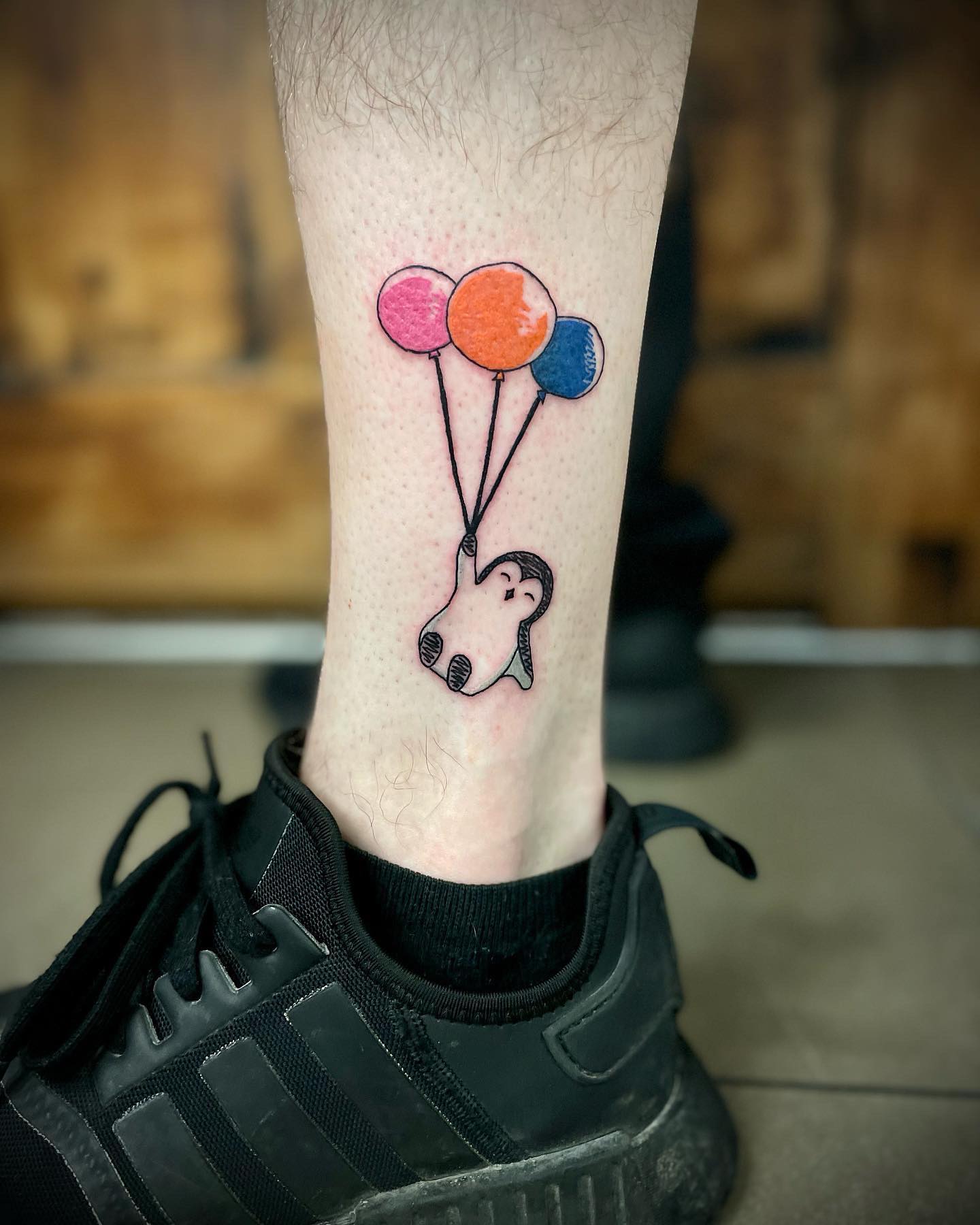 In this tattoo design, the penguin holds some colorful balloons and it seems like it is enjoying them a lot. Maybe all you need is a cute tattoo like this.