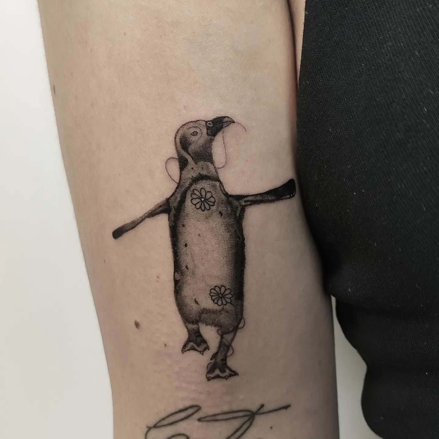 Here is a creative and unique design for you. Unlike most of the penguin tattoos, this tattoo is sure to give you a different look that others will notice.