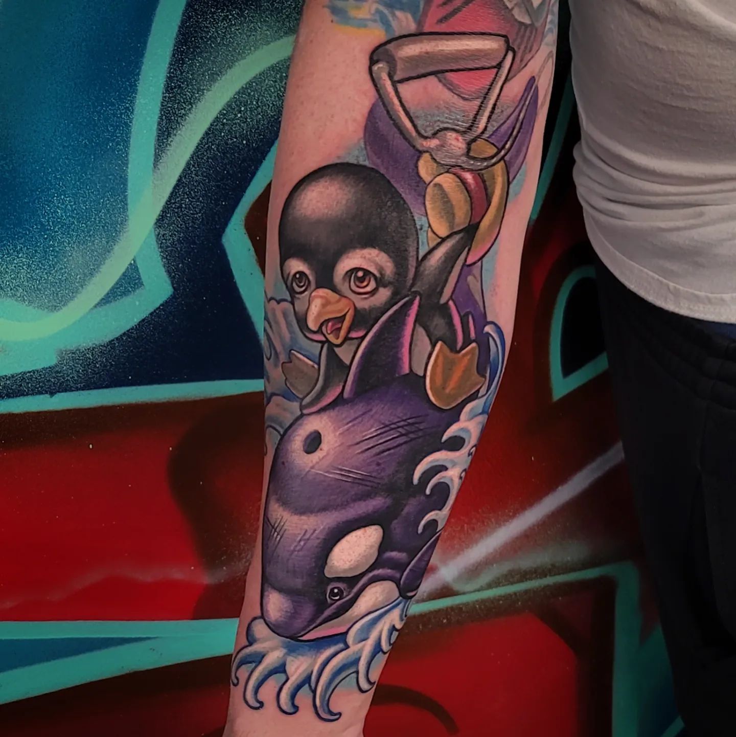 How amazing the color palette is in this tattoo! The combo of Orca and a penguin will take your tattoo to a different level.