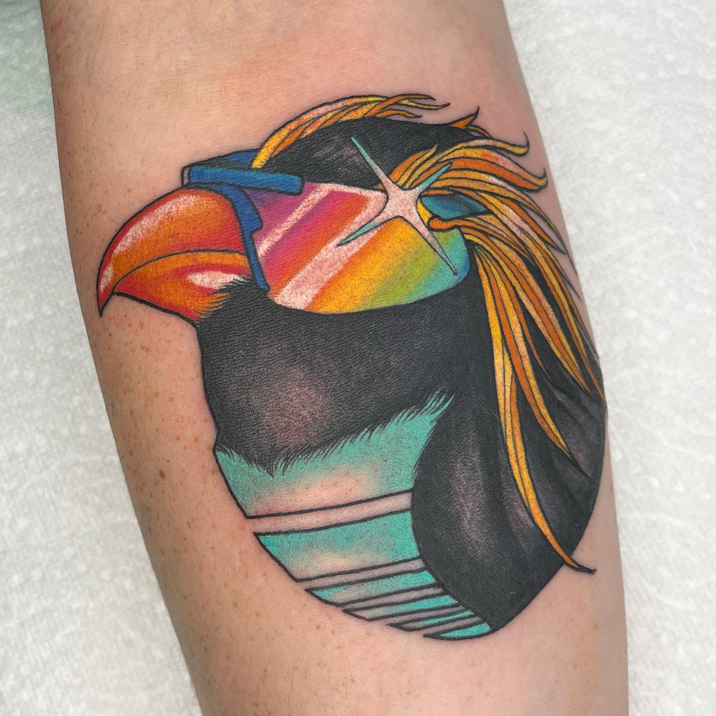 It is so hard to resist this cool penguin head design, isn't it? Its color palette will take your tattoo to a whole different level and everyone will come closer to check it out.
