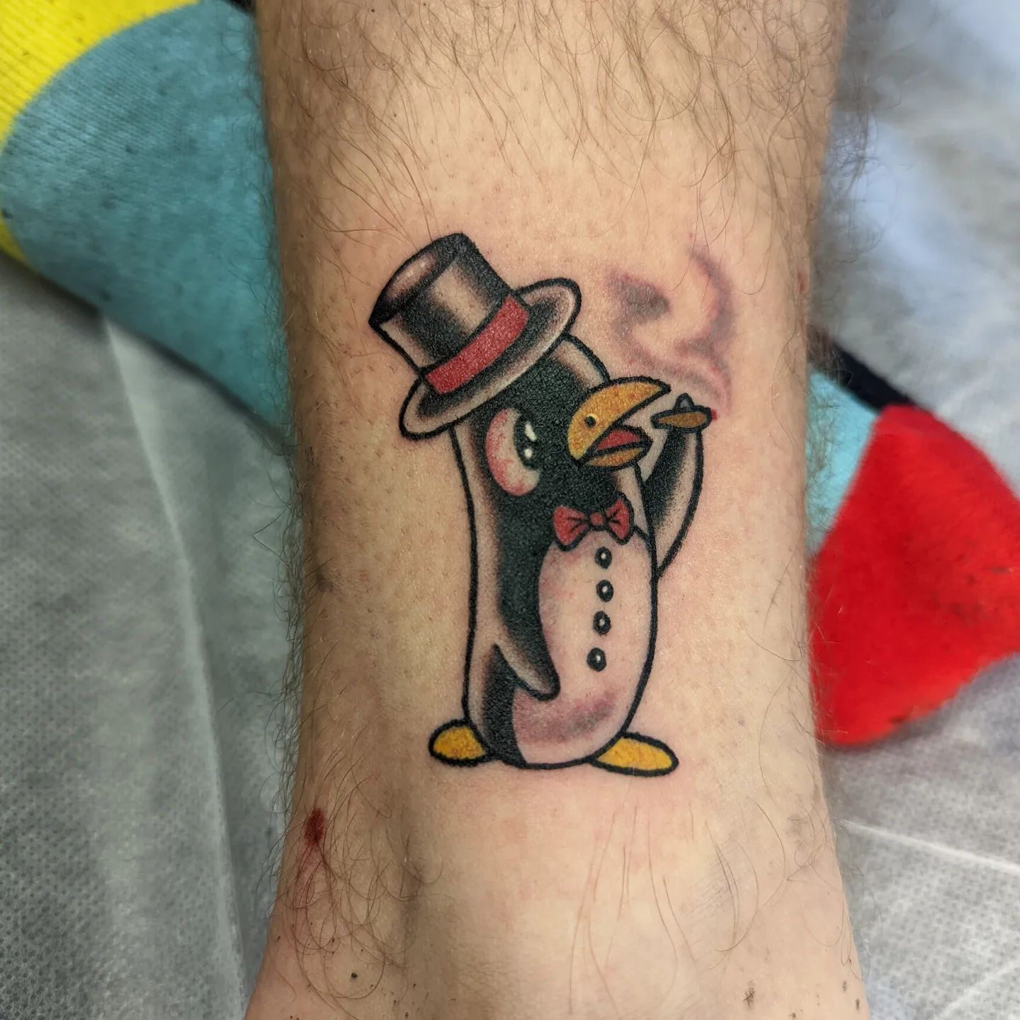 Smoking is a bad habit but a penguin with a cigar on his hand looks cool. Plus, his hat rocks!