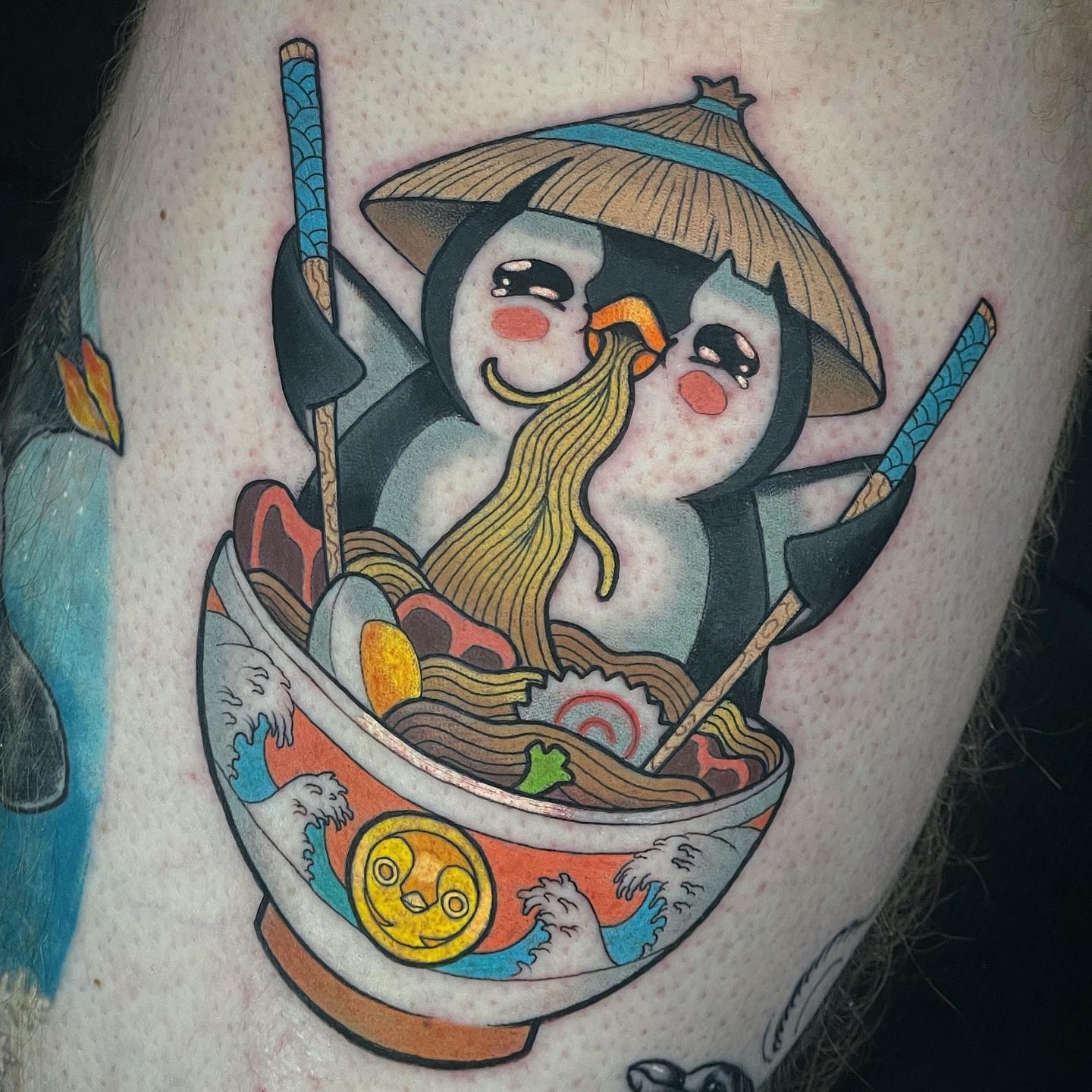 How does 'a penguin bowl' sound? In this colorful and unusual tattoo, a Japanese penguin is waiting for you to melt your heart.