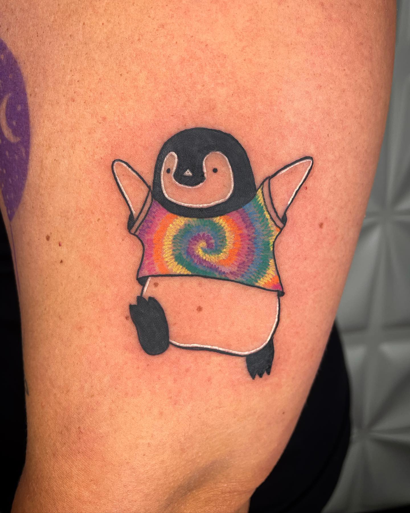 A penguin wearing a batik T-shirt sound weird but you know, there is no limit for imagination. Go for this fun and creative tattoo.