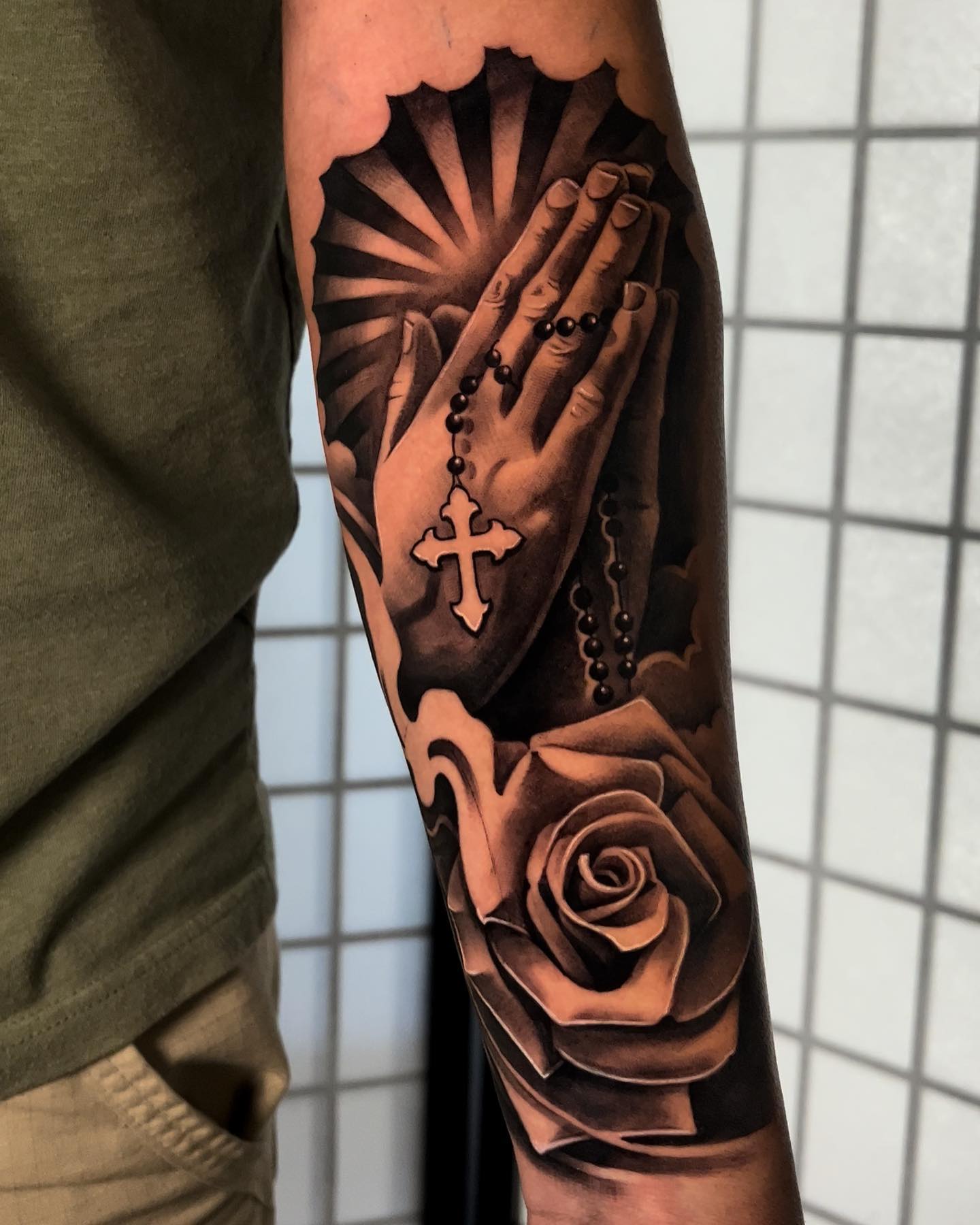 Along with that rose, this tattoo looks super-realistic. To show your love to your religion, this one is a perfect choice for it.